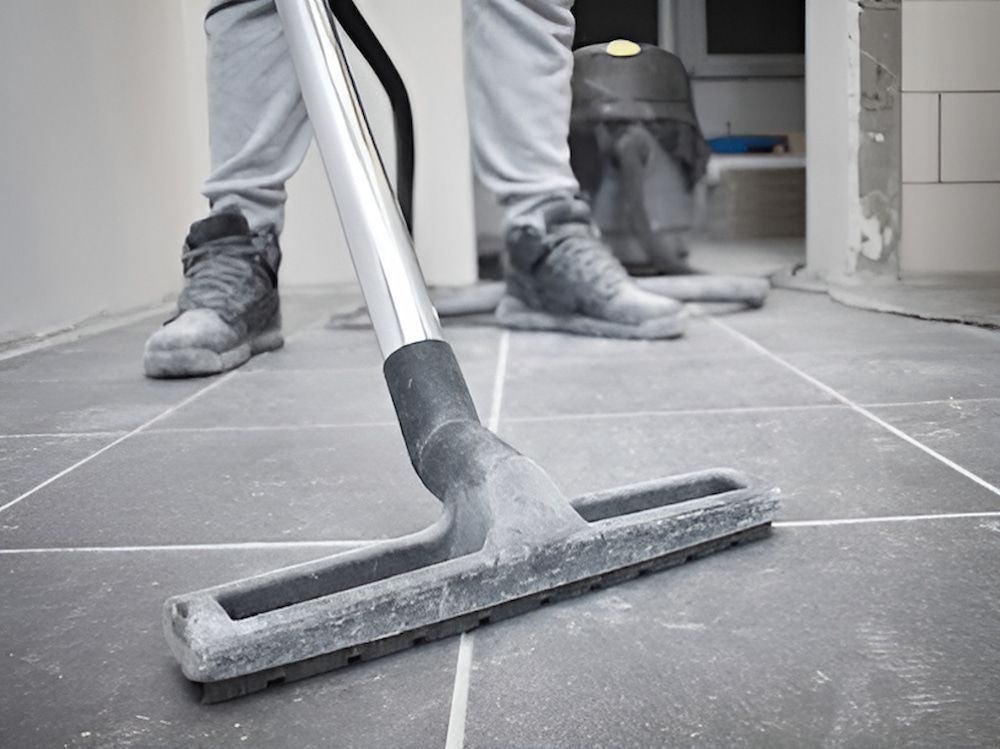 A Person Is Using A Vacuum Cleaner To Clean A Tiled Floor — Crystal Clear In Uralla, NSW