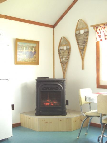 A room with a fireplace and snowshoes on the wall