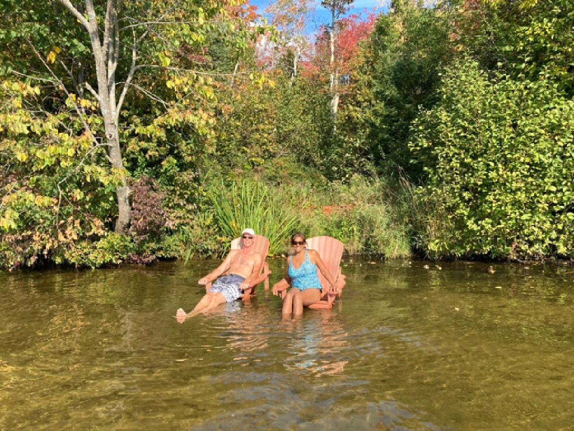 A couple sitting in the water