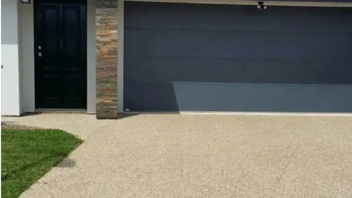 Exposed red aggregate concrete driveway
