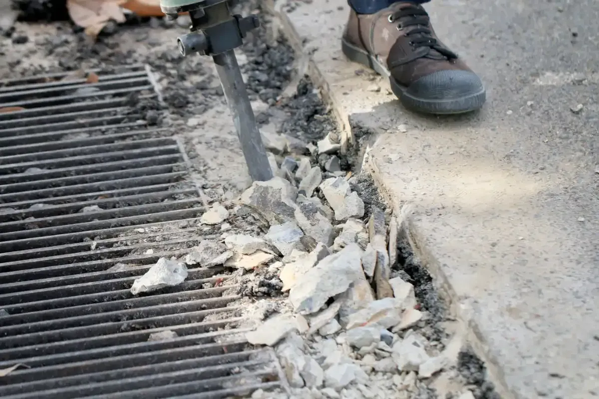 cracked concrete sidewalk to be repaired