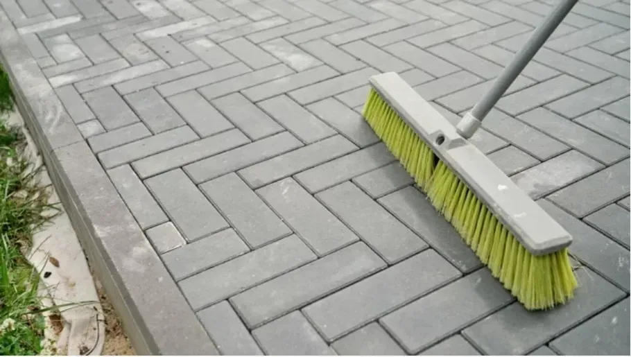 Brushing concrete paved driveway