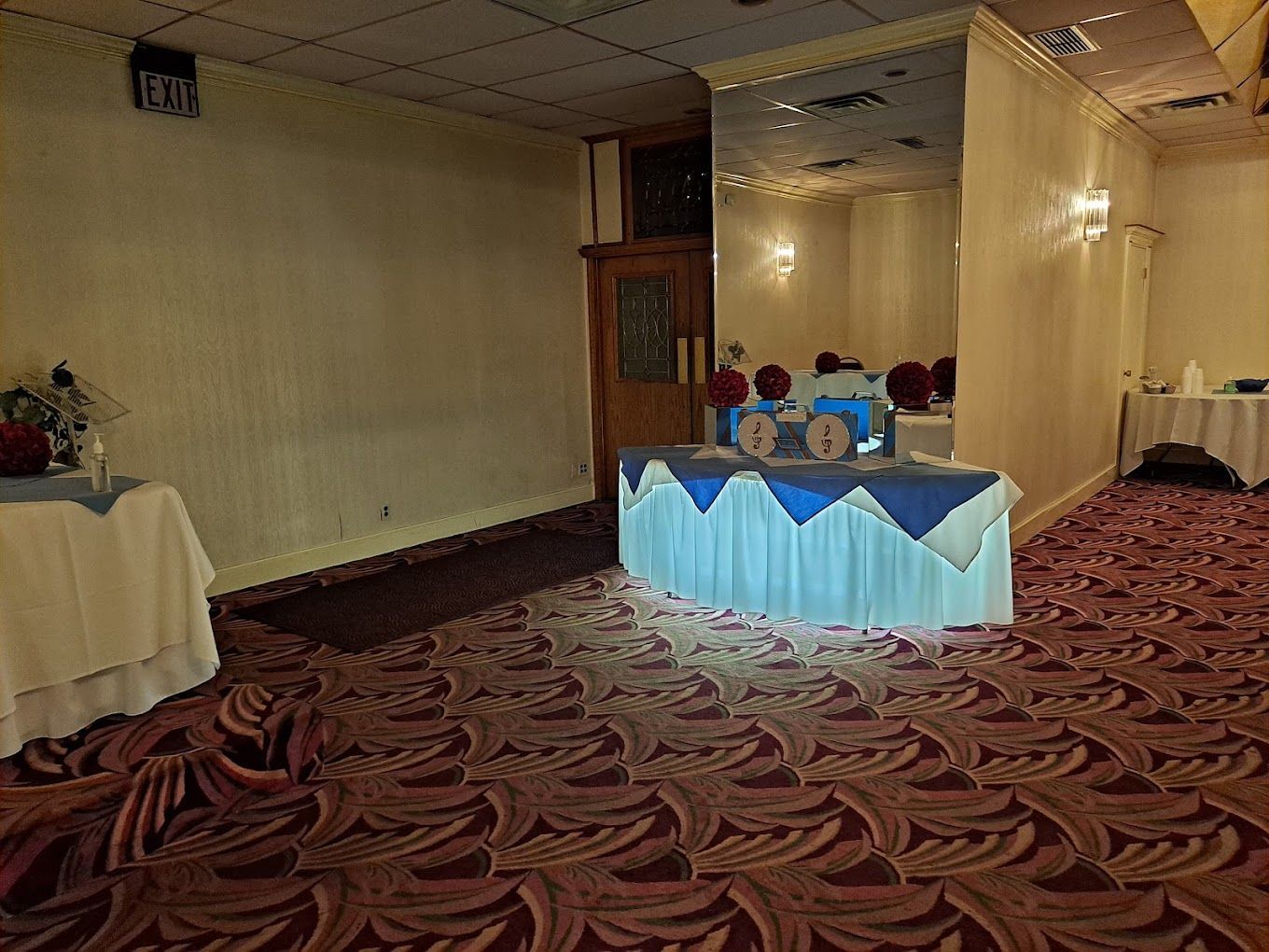 There is a table with a blue table cloth in the middle of the room