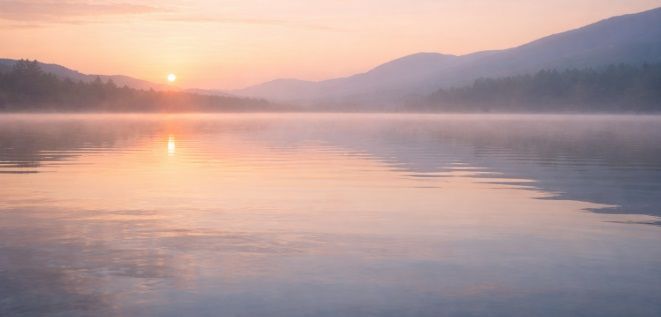 sunrise over a calm lake with cremation services in Whiteland, IN