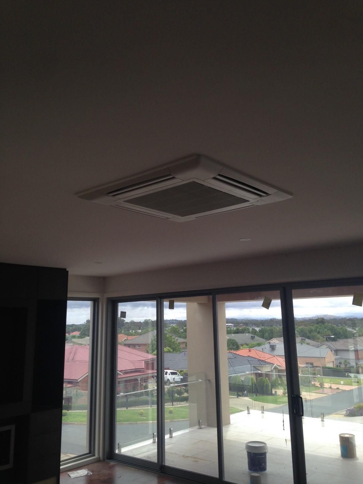 A Living Room With A Lot Of Windows And A Cassette Air Conditioner — Custom Air In East Albury, NSW