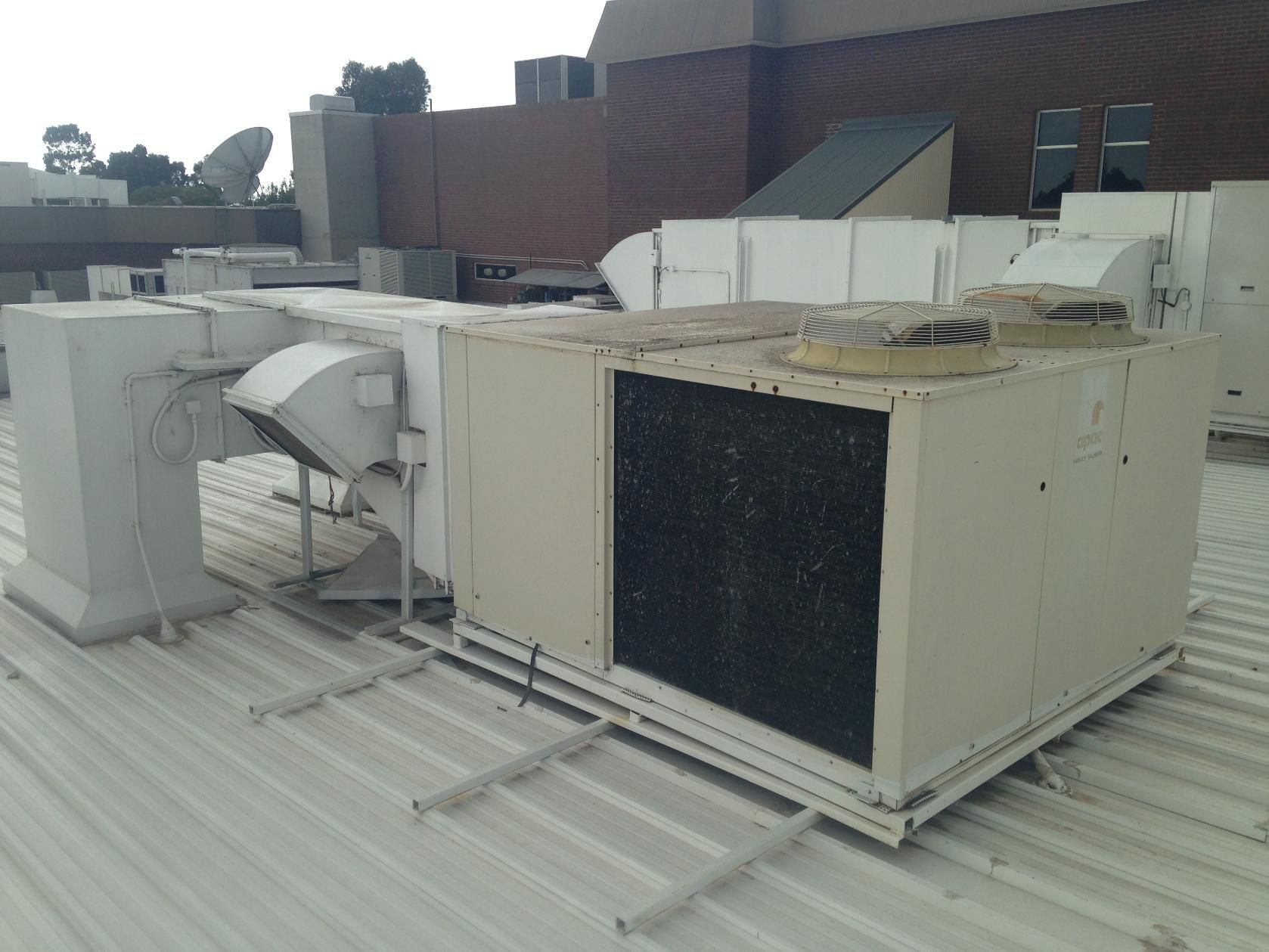 The Roof Of A Building Has A Lot Of Air Conditioning Equipment On It — Custom Air In East Albury, NSW