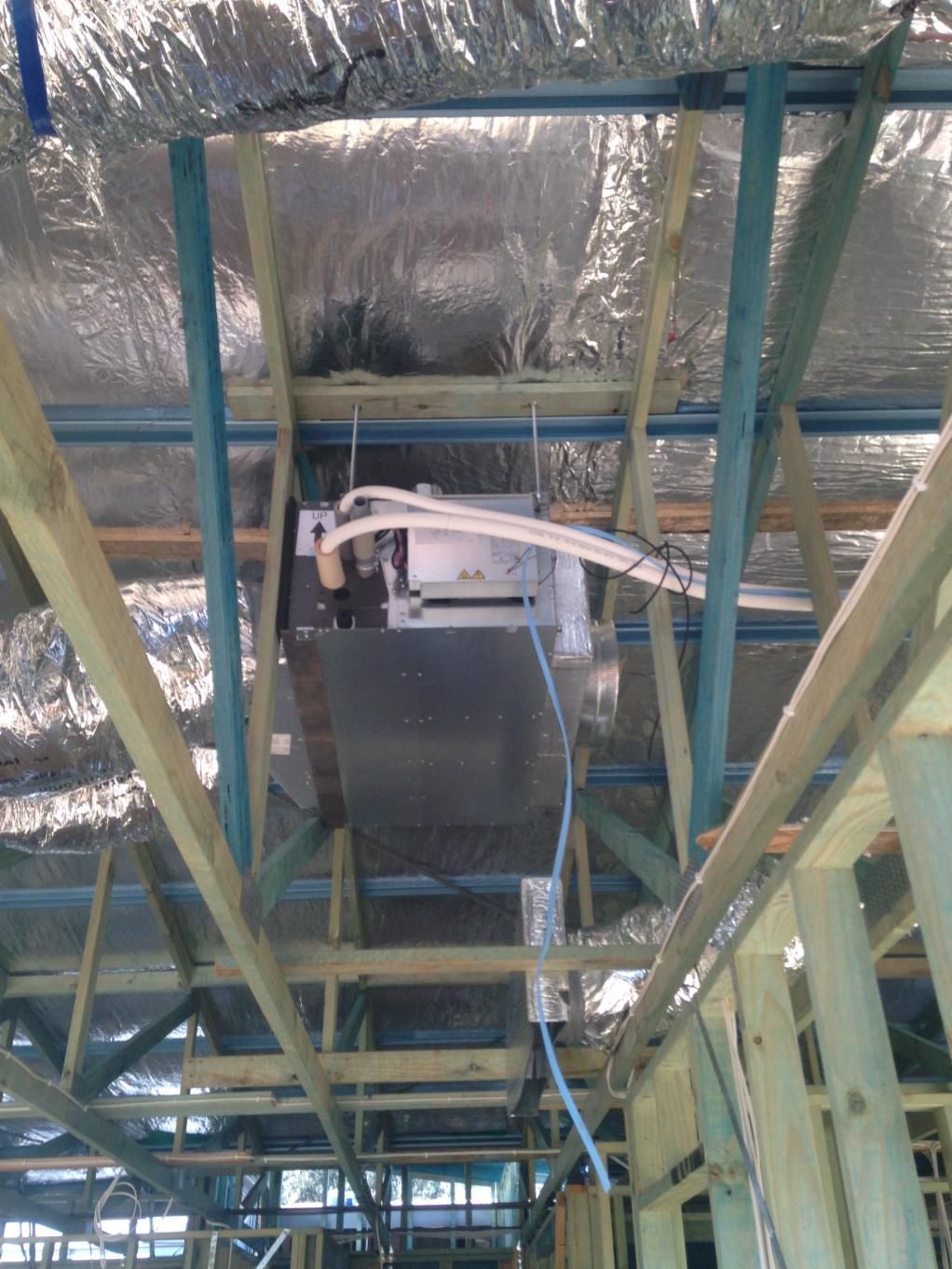 The Ceiling Of A Building Under Construction With A Duct Hanging From It — Custom Air In East Albury, NSW