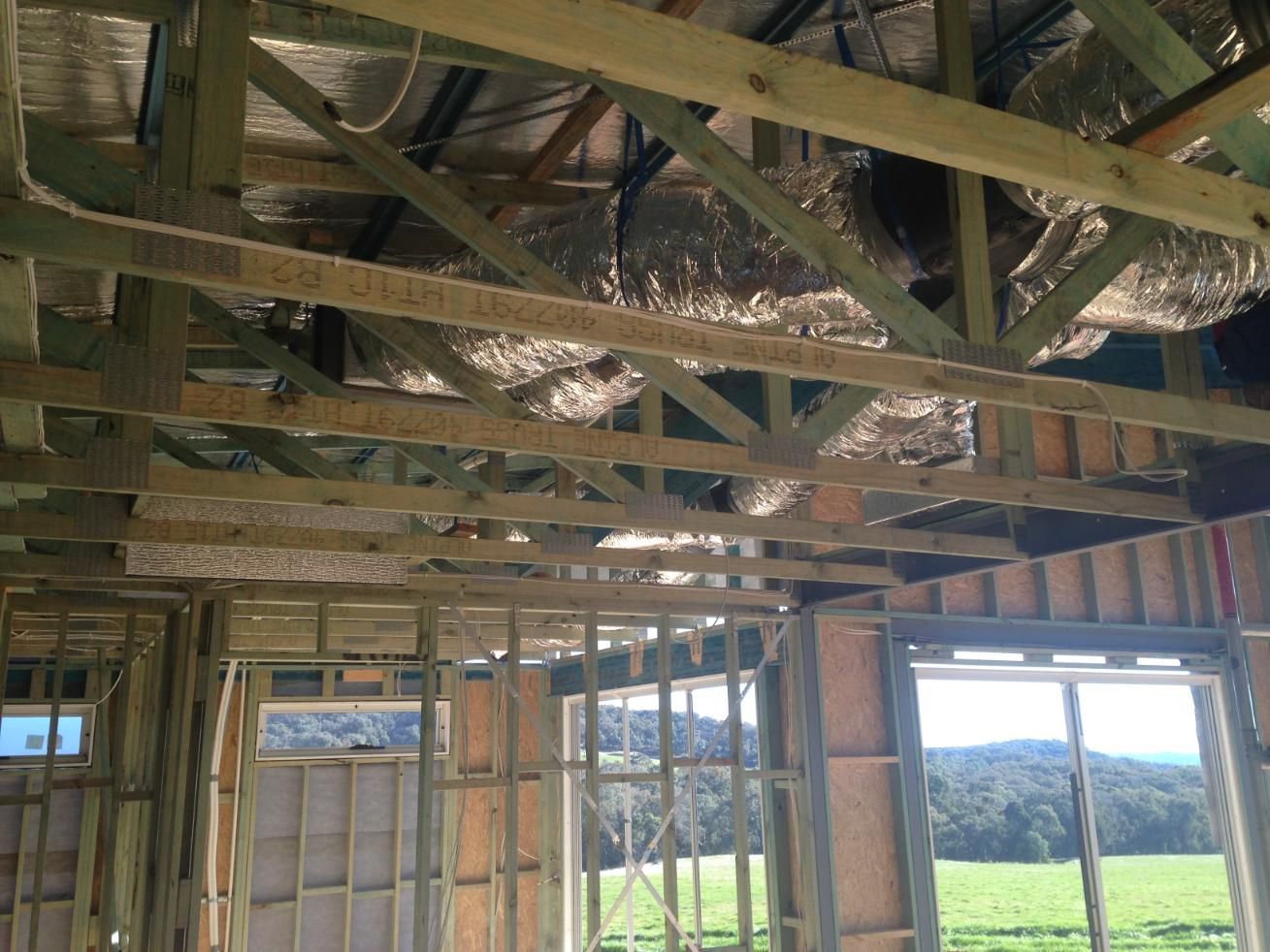 A House Is Being Built With A Lot Of Wooden Beams — Custom Air In East Albury, NSW