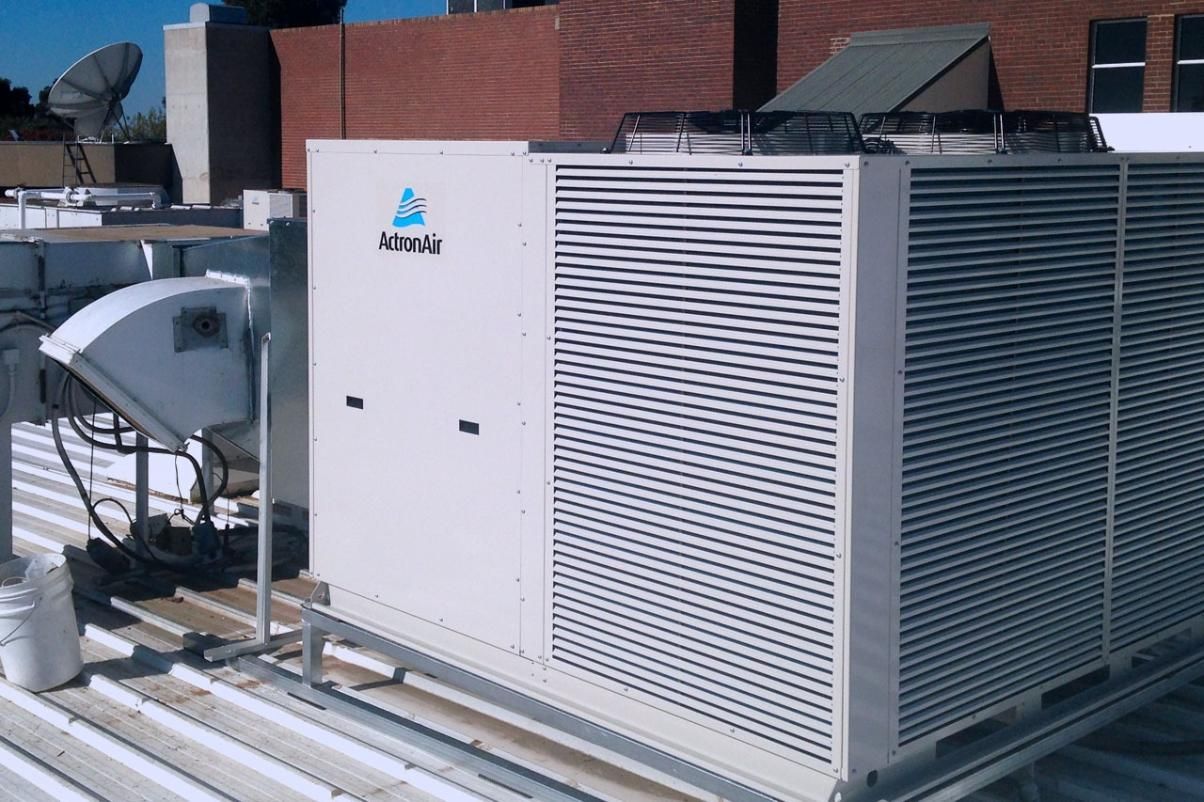 A Large Air Conditioner Is On The Roof Of A Building — Custom Air In Wodonga, NSW