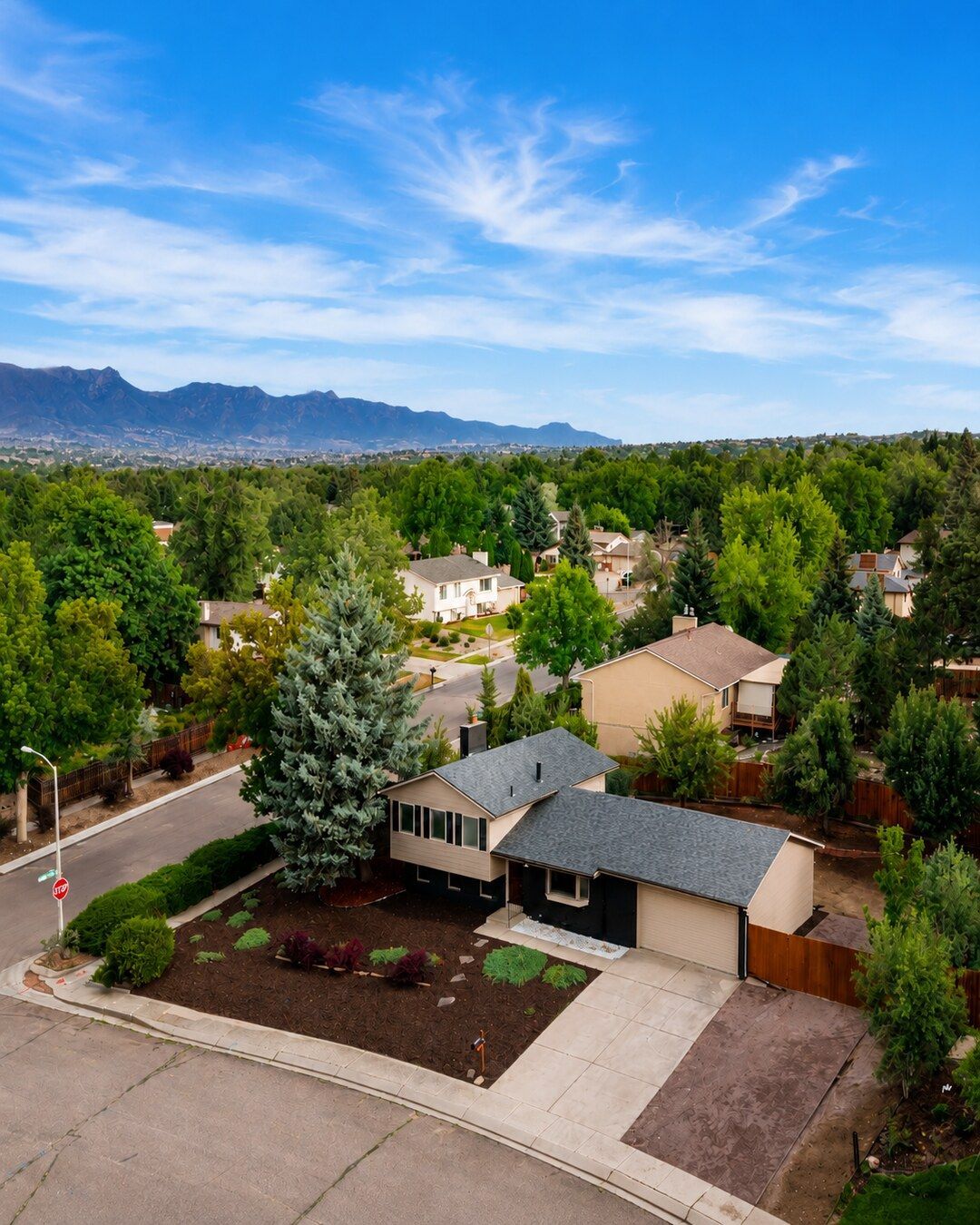 Brown shingle roof with intersecting ridgelines and a dark gutter along the edge