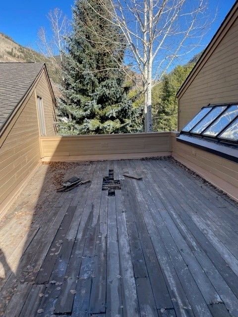 Wooden deck with damaged floorboards needing repair and maintenance.