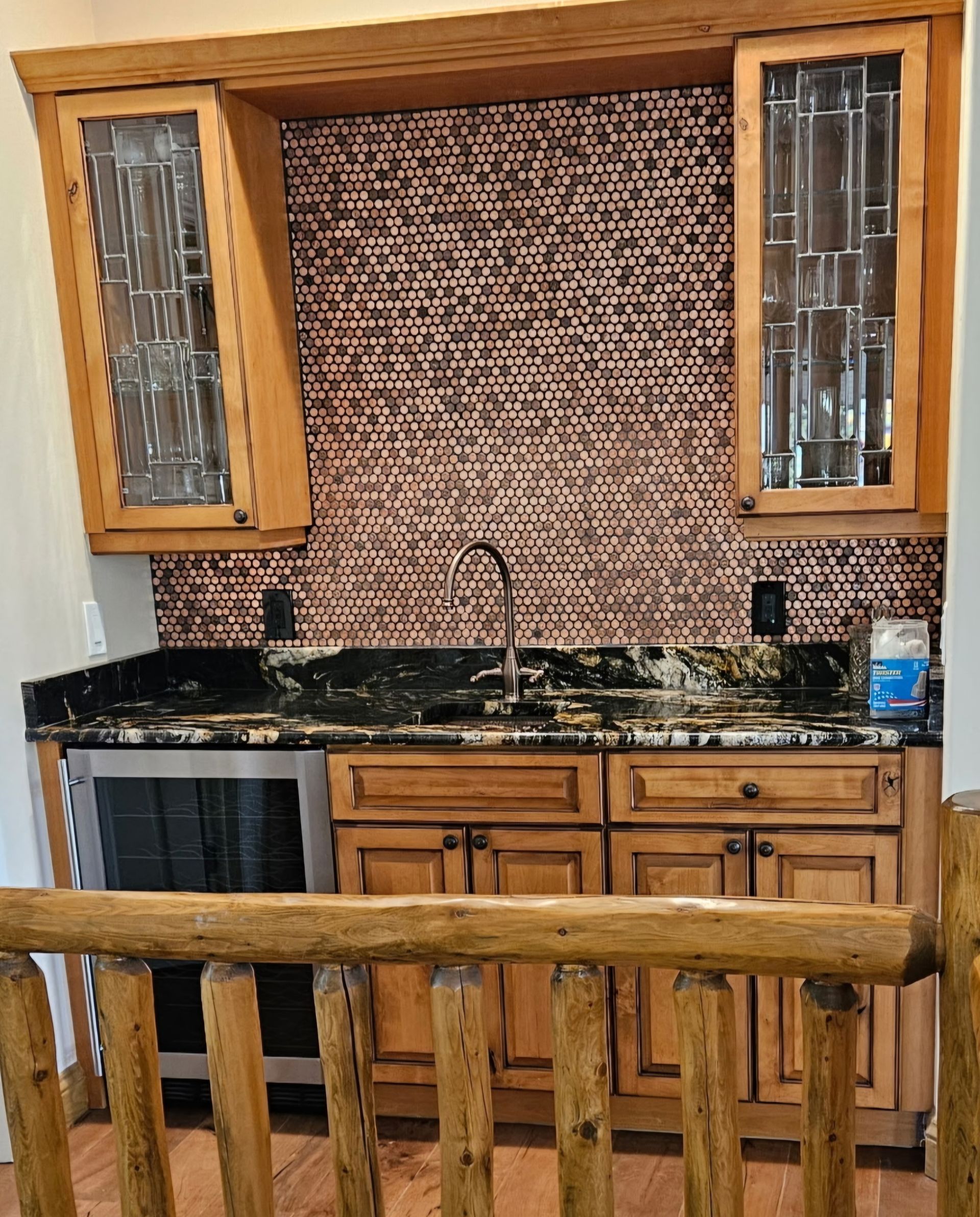 mosaic kitchen backsplash between custom wood cabinets