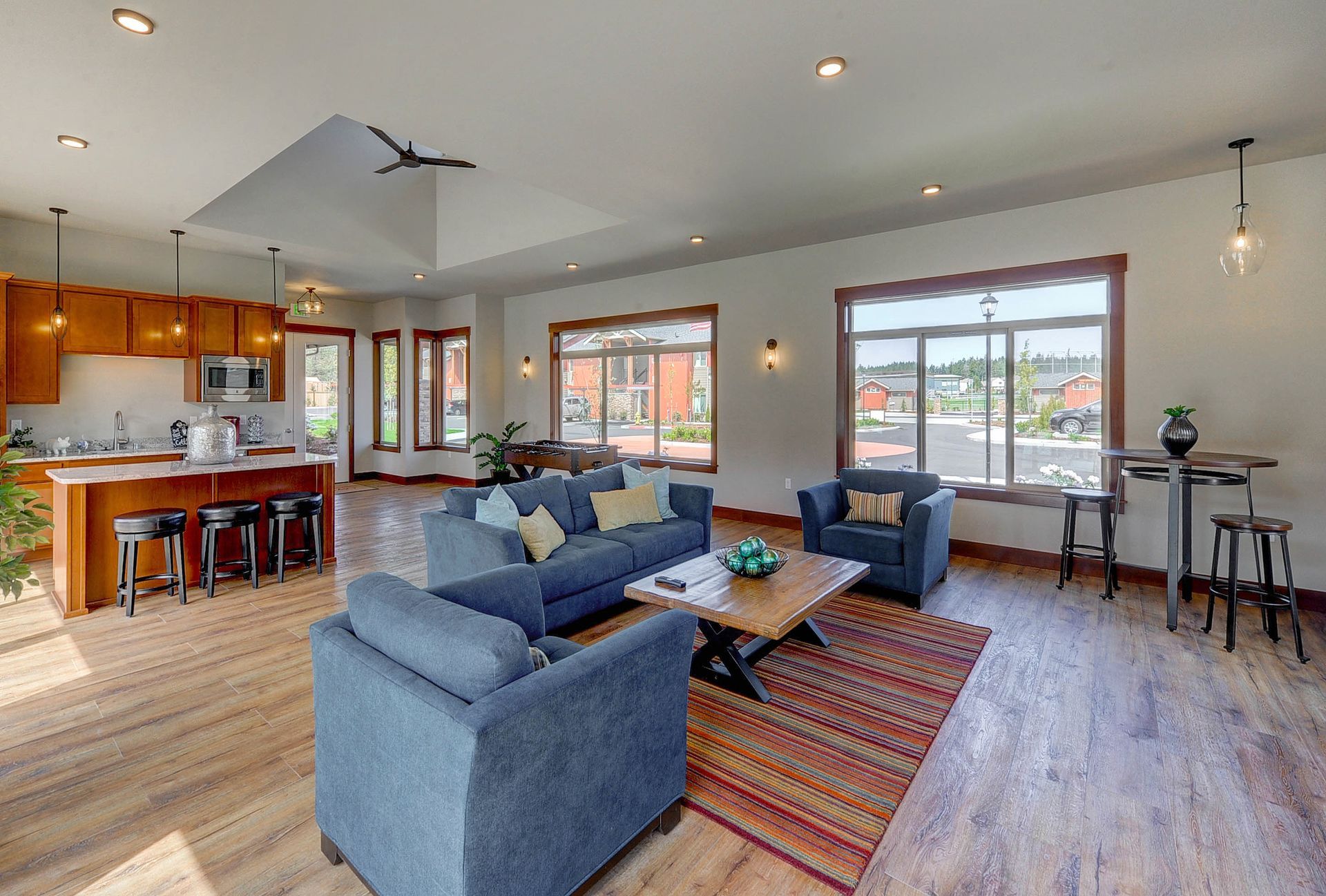 a living room with a blue couch and two chairs