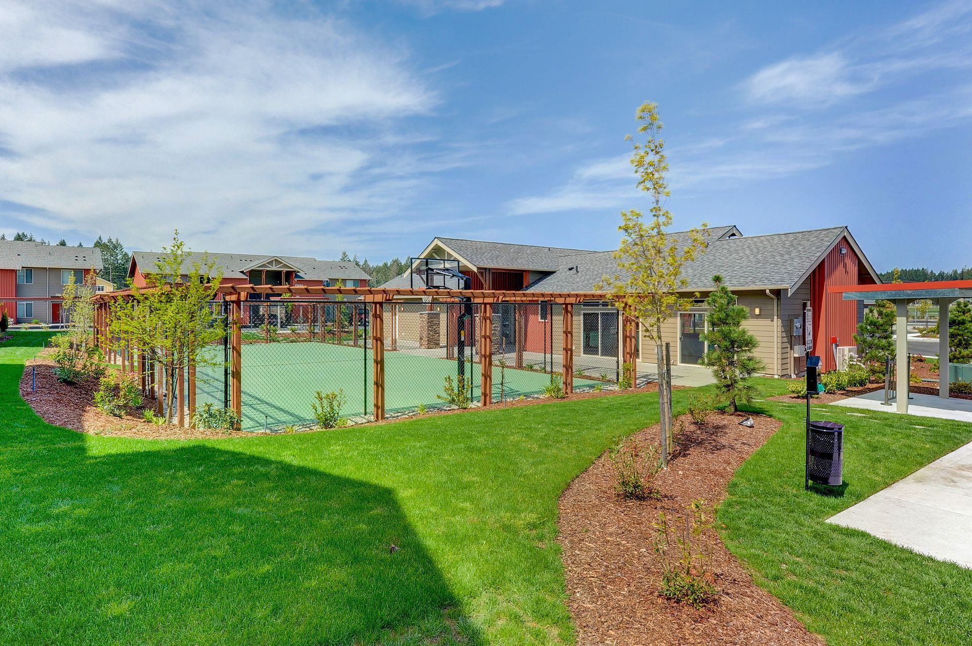 a tennis court with a basketball hoop in the background