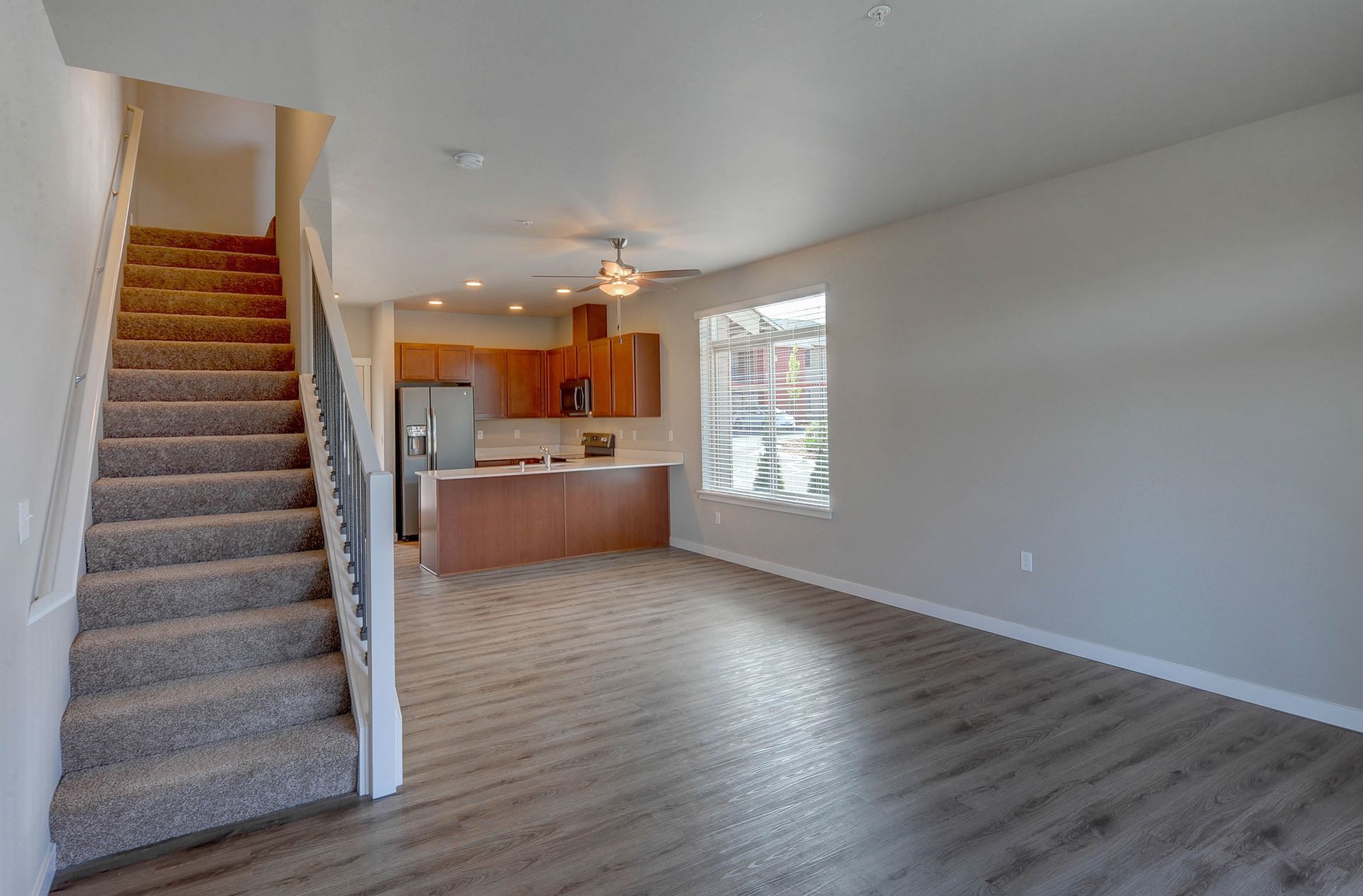 a kitchen with a staircase leading up to it