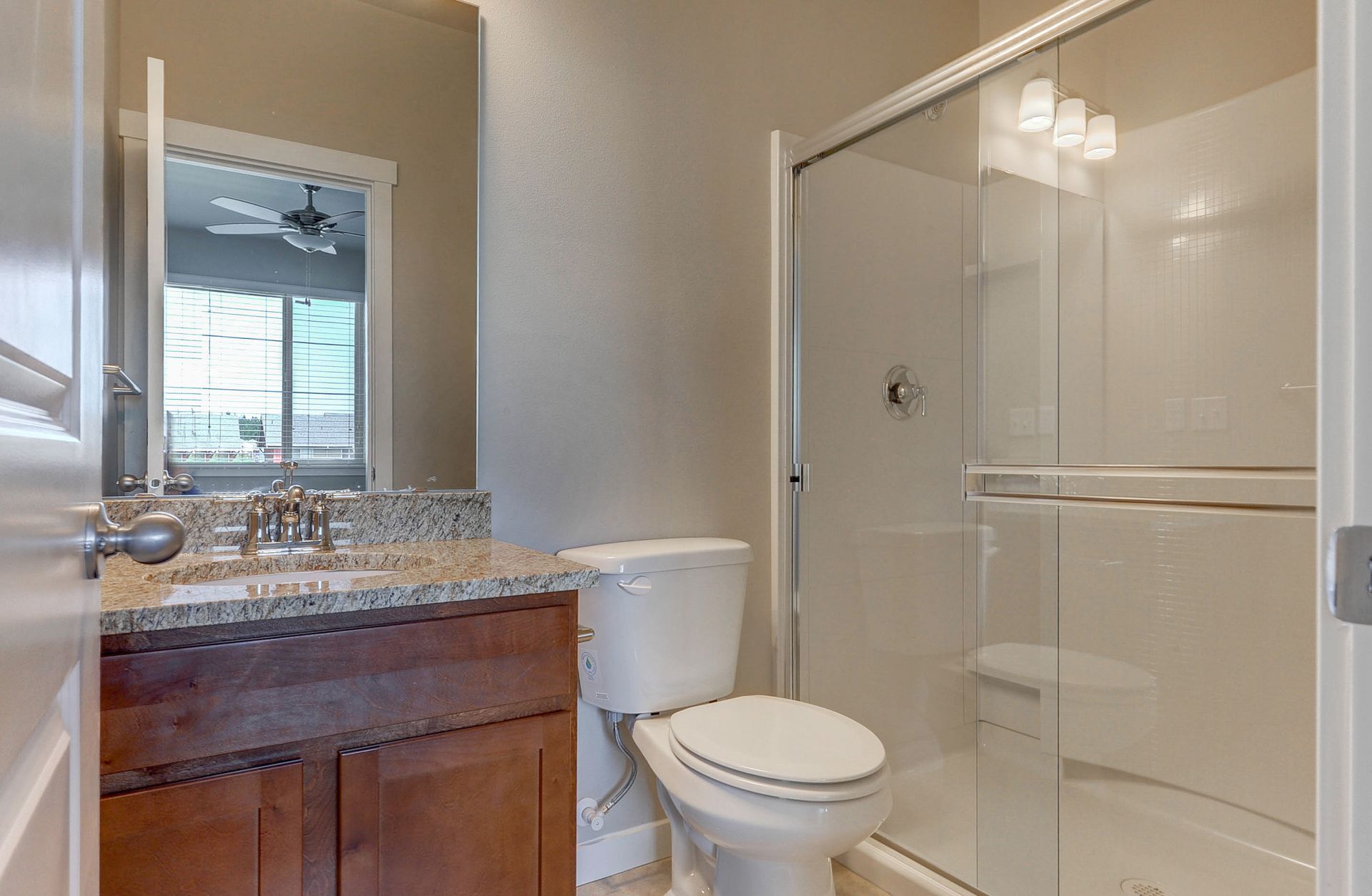 a bathroom with a toilet a sink and a walk in shower