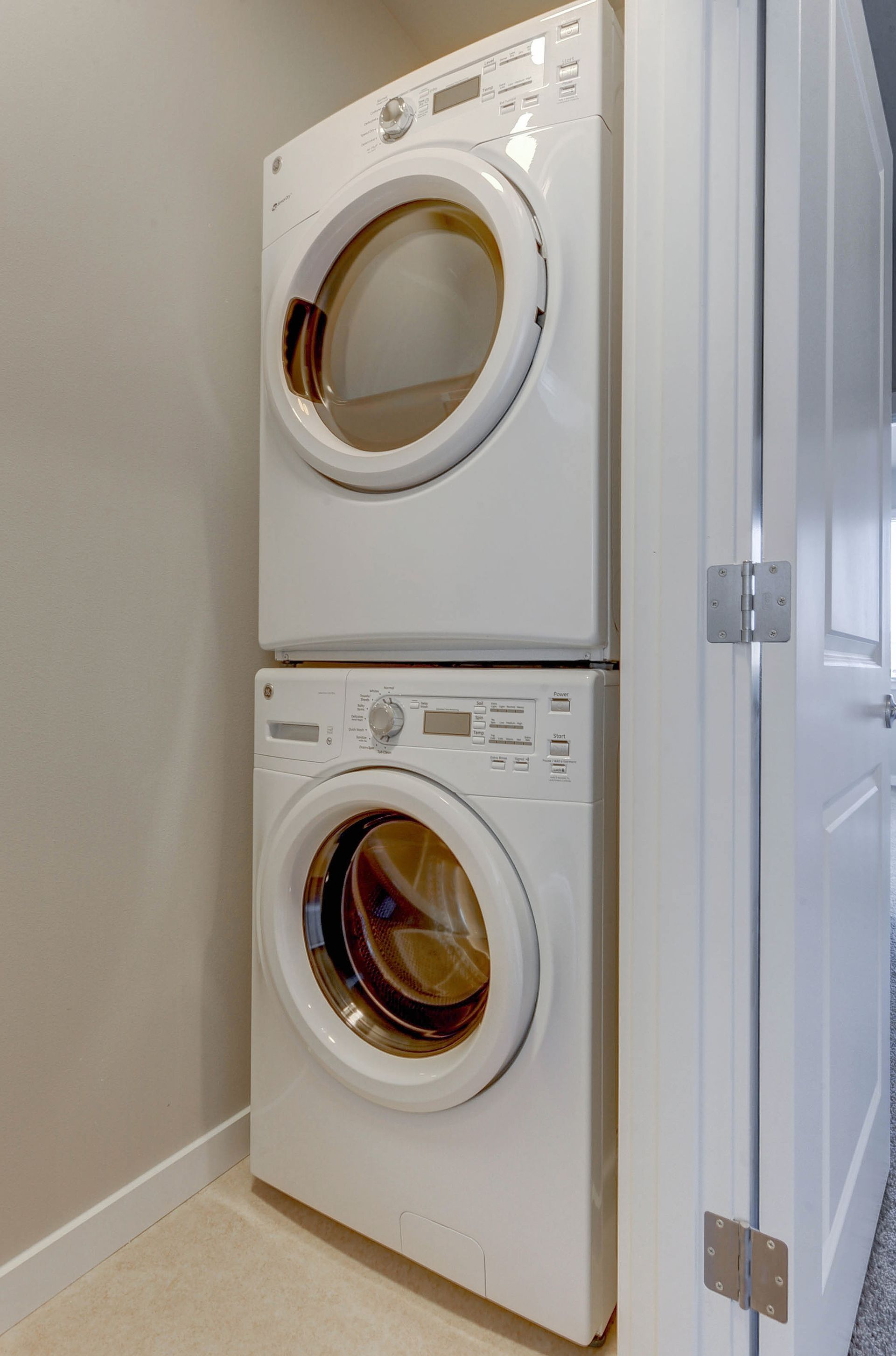 a white washer and dryer are stacked on top of each other