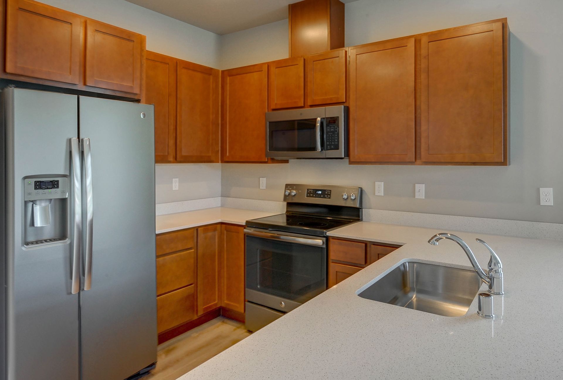 a kitchen with stainless steel appliances and wooden cabinets