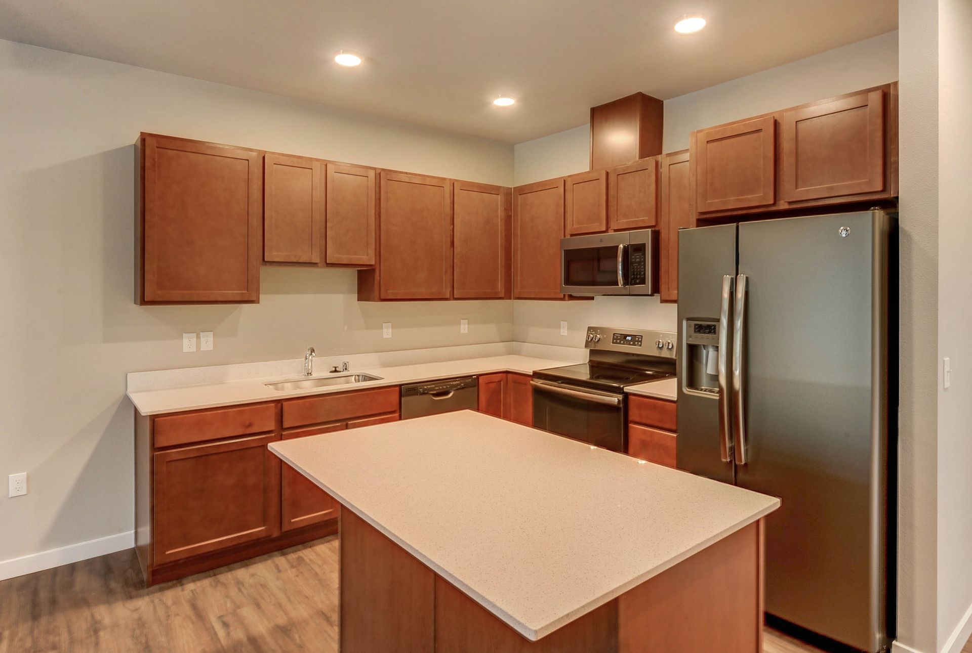 a kitchen with stainless steel appliances and wooden cabinets