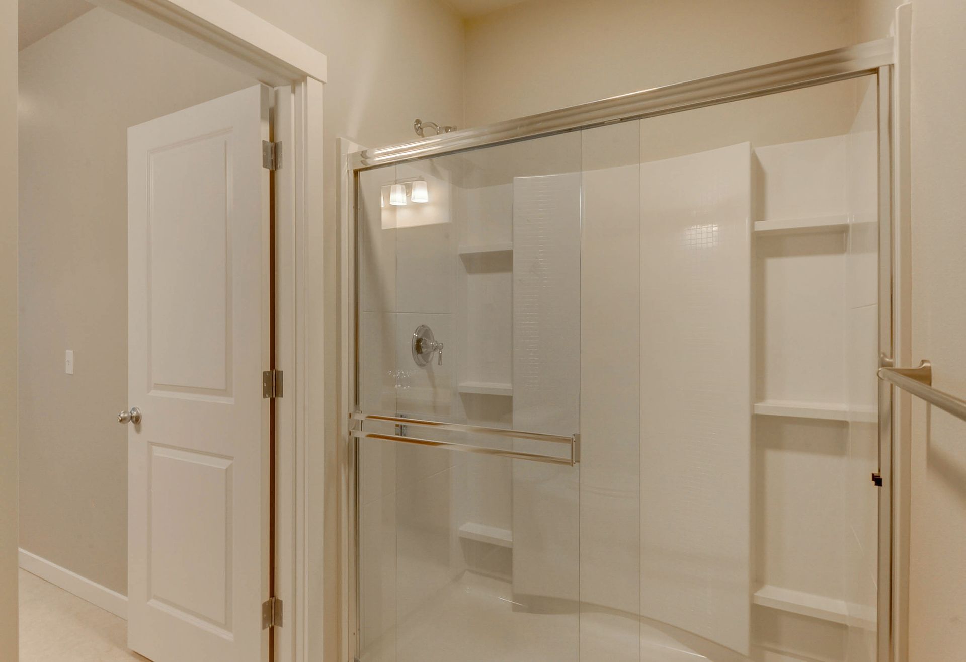 a walk in shower with a clear glass door