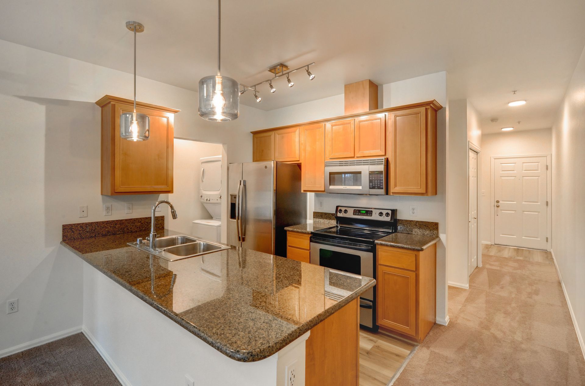 a kitchen with stainless steel appliances and granite counter tops