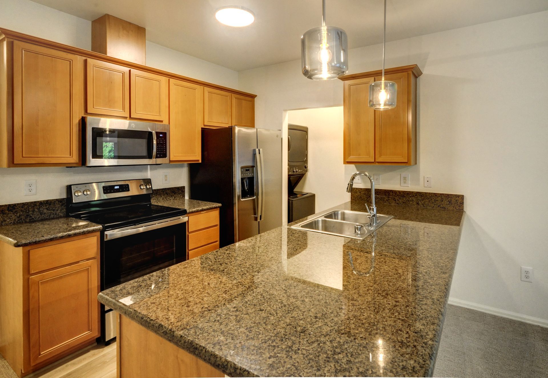 a kitchen with granite counter tops and stainless steel appliances