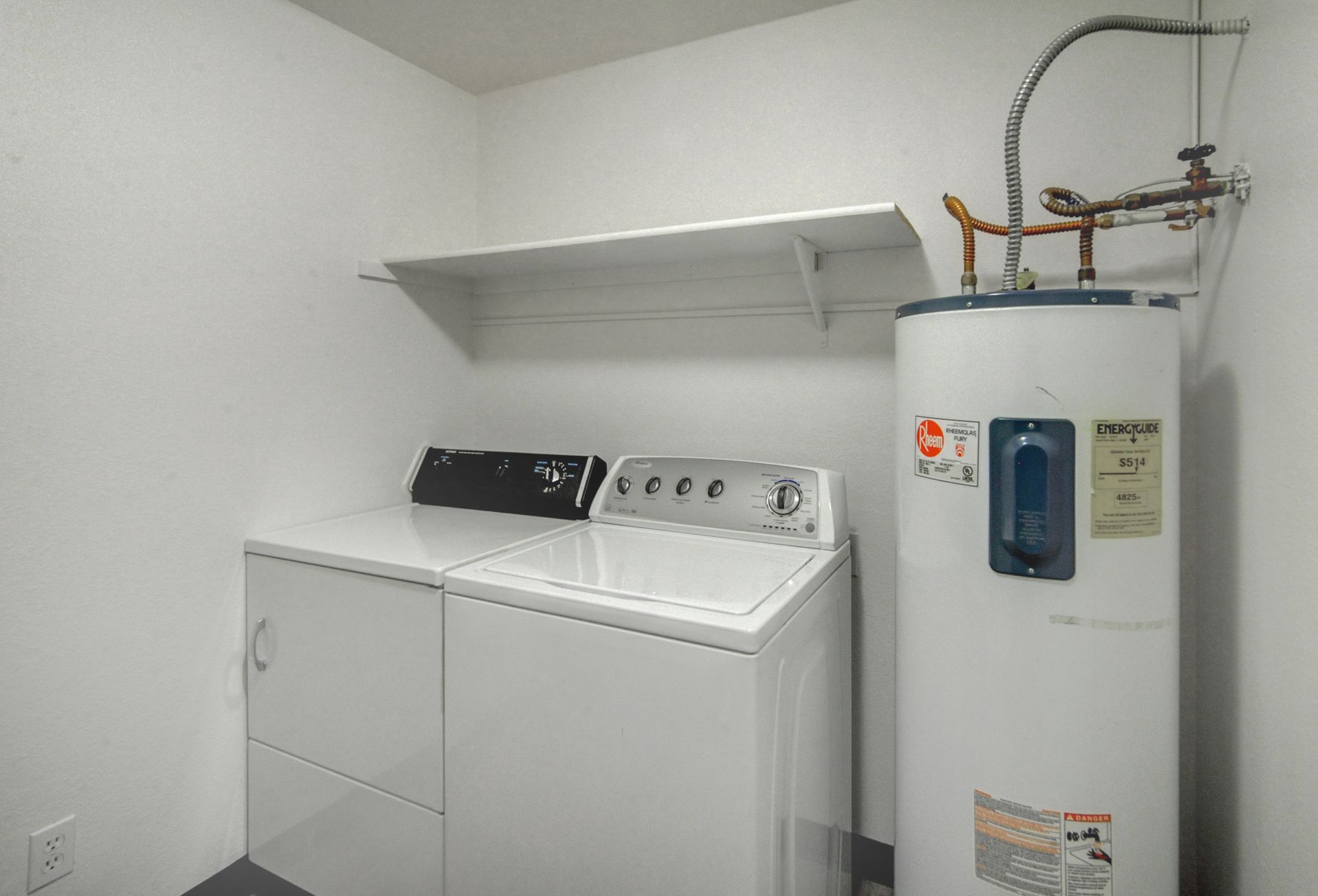 a whirlpool washer and dryer in a laundry room