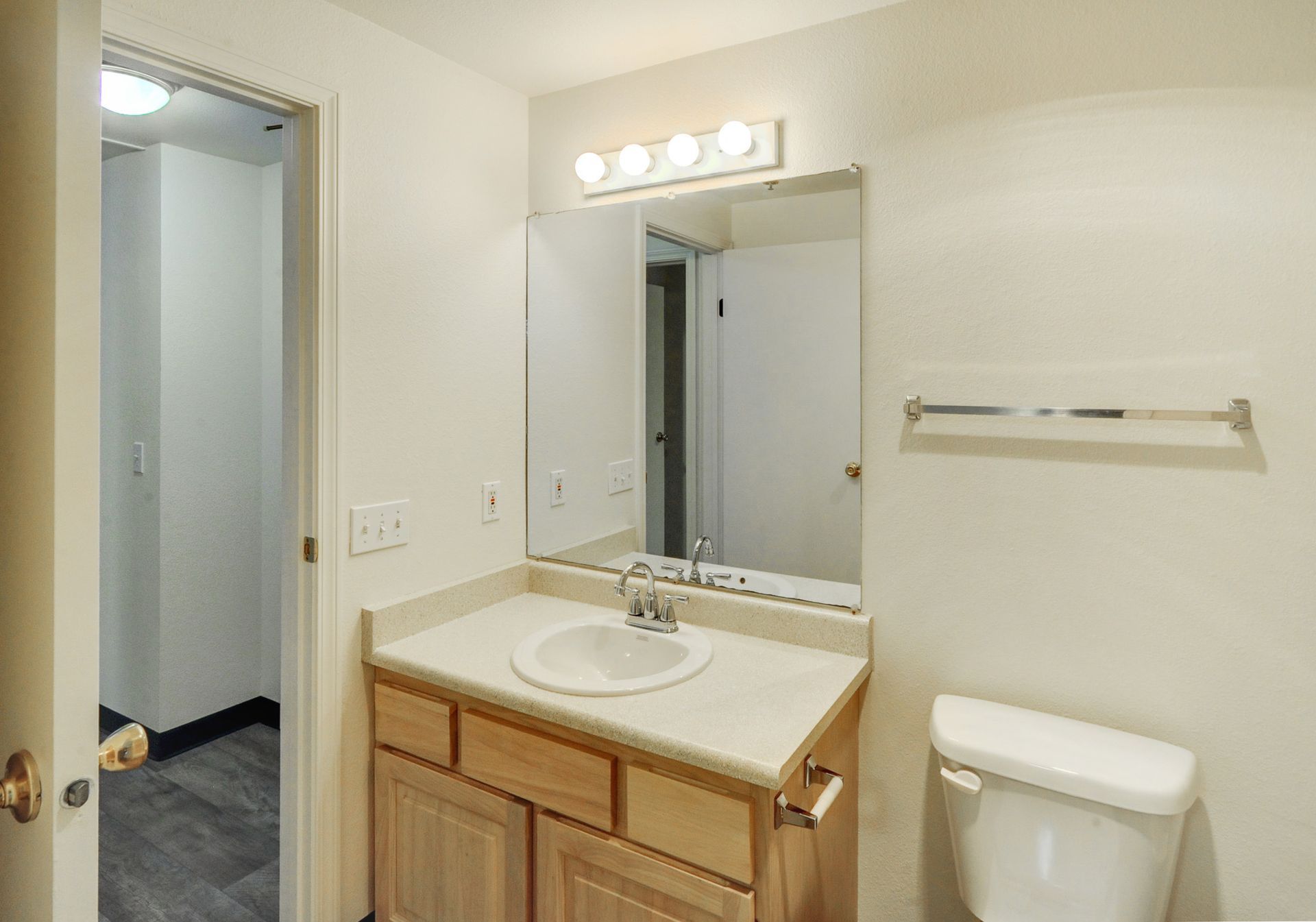 a bathroom with a sink a toilet and a mirror