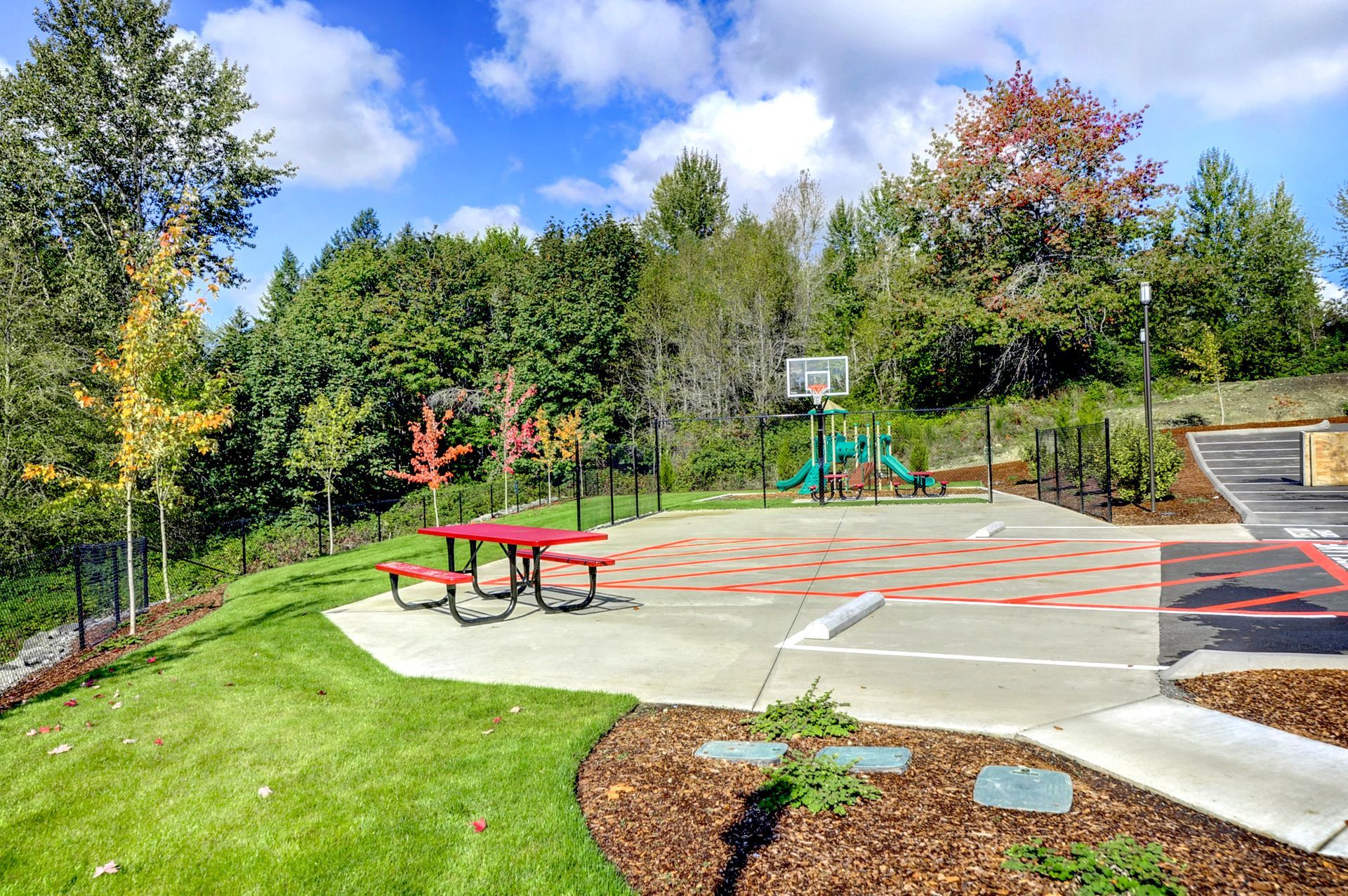 there is a picnic table in the middle of the park .