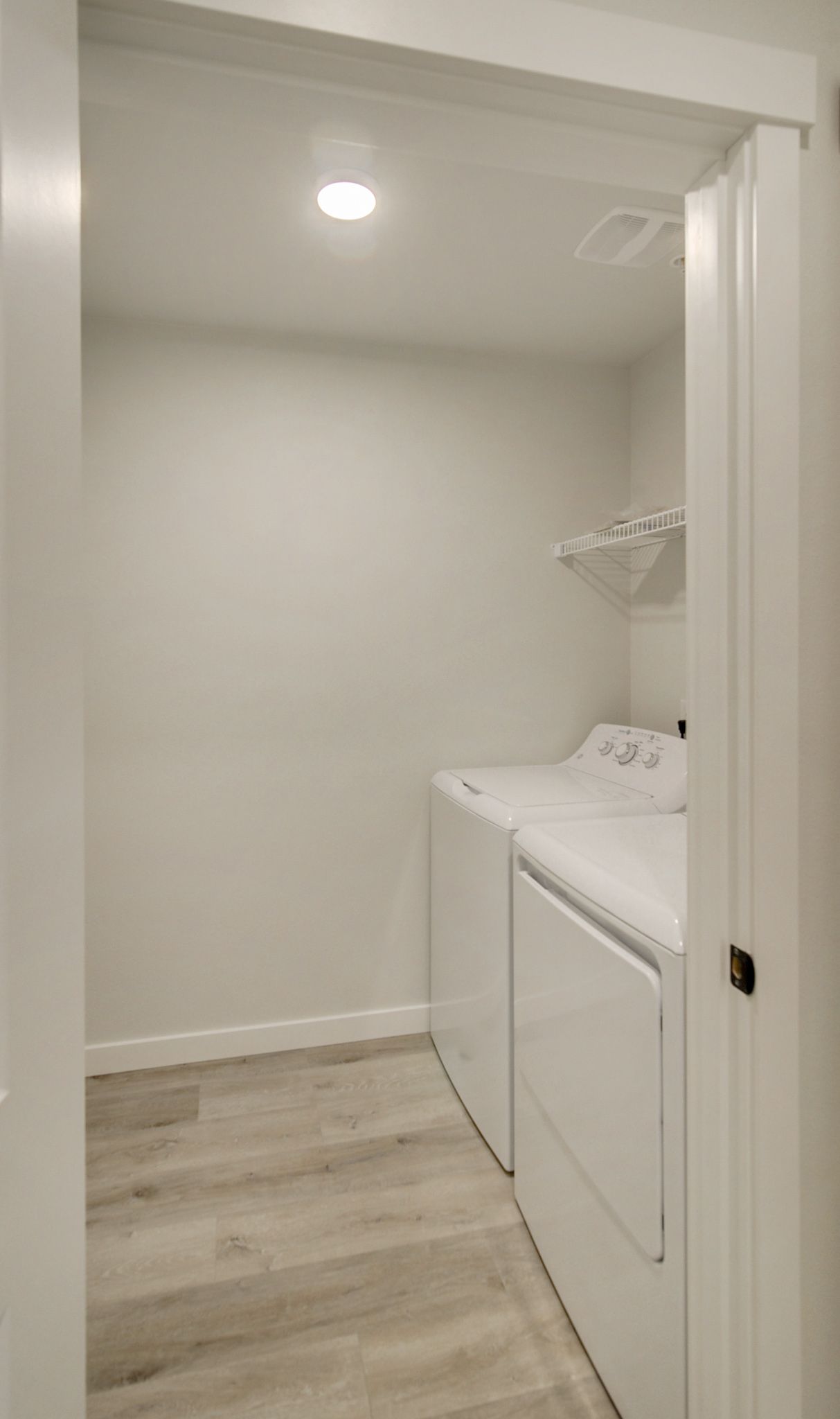 a laundry room with a washer and dryer in a house .