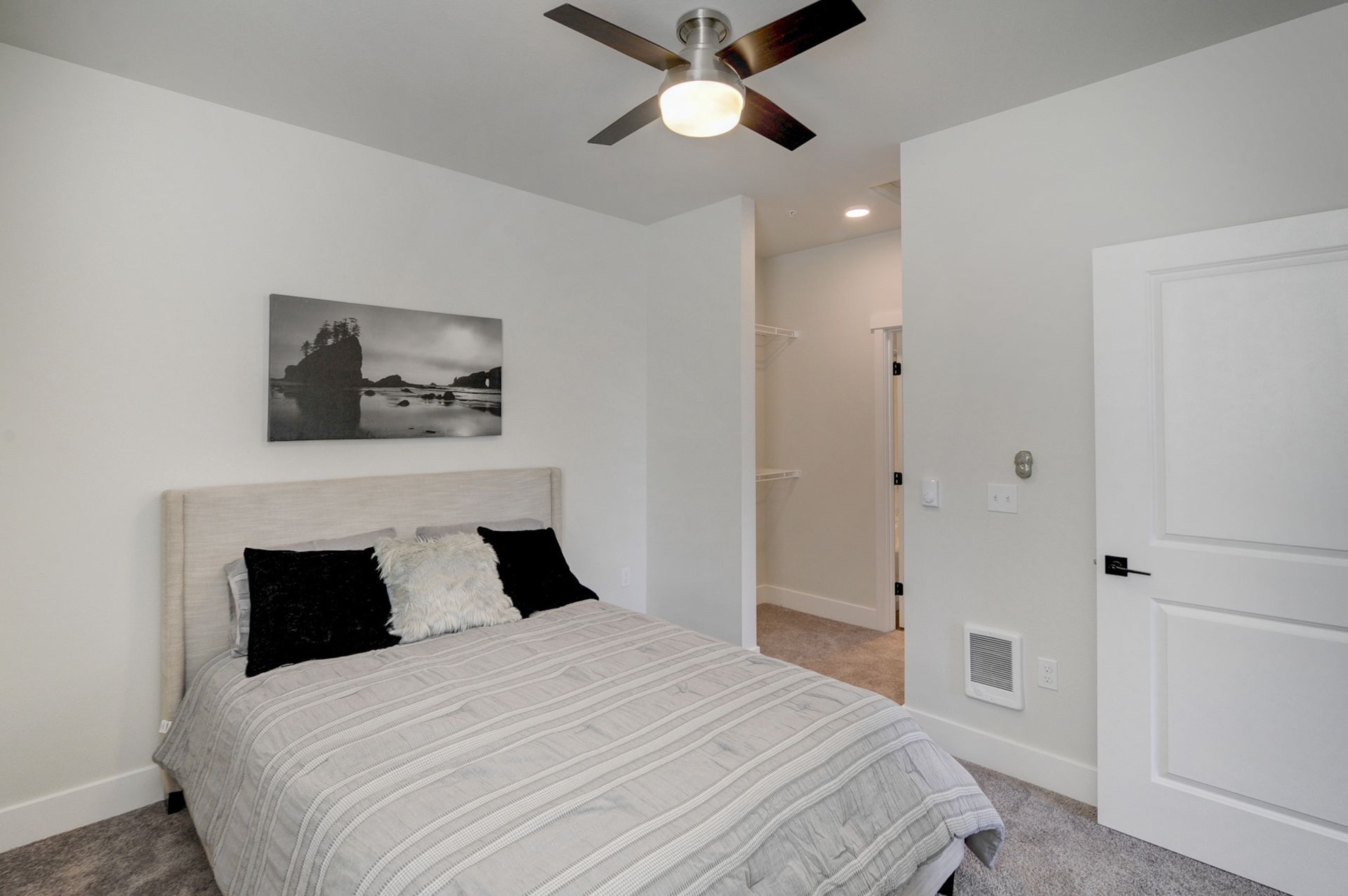 a bedroom with a bed and a ceiling fan .