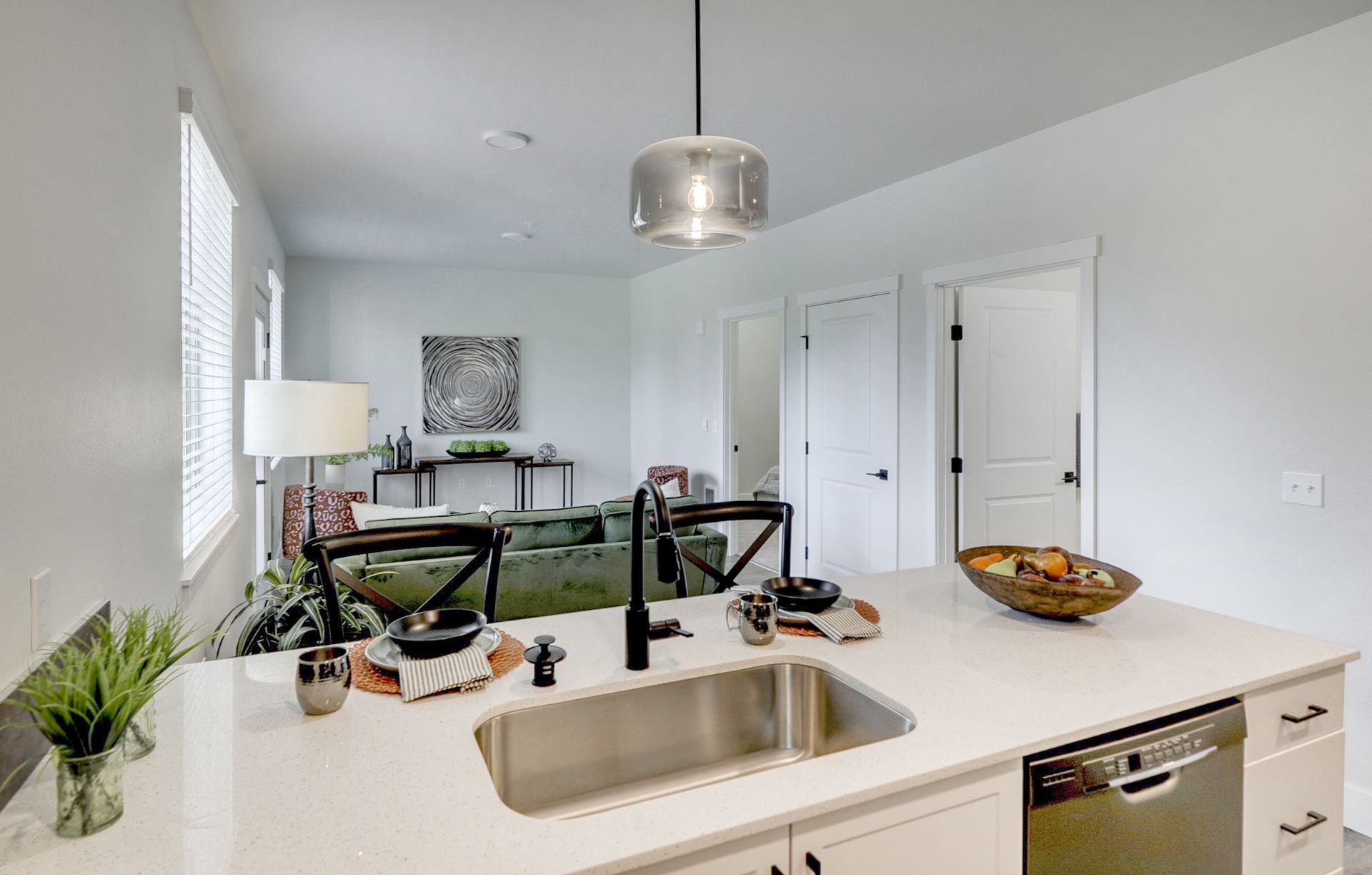 a kitchen with a stainless steel sink and a dishwasher .