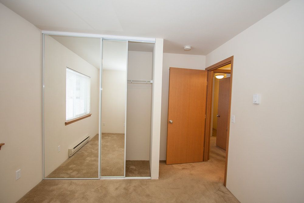 a bedroom with a closet and a door