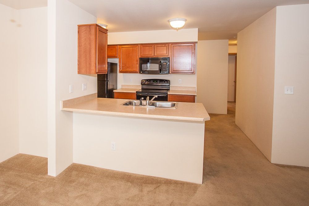 a kitchen with a sink stove and microwave