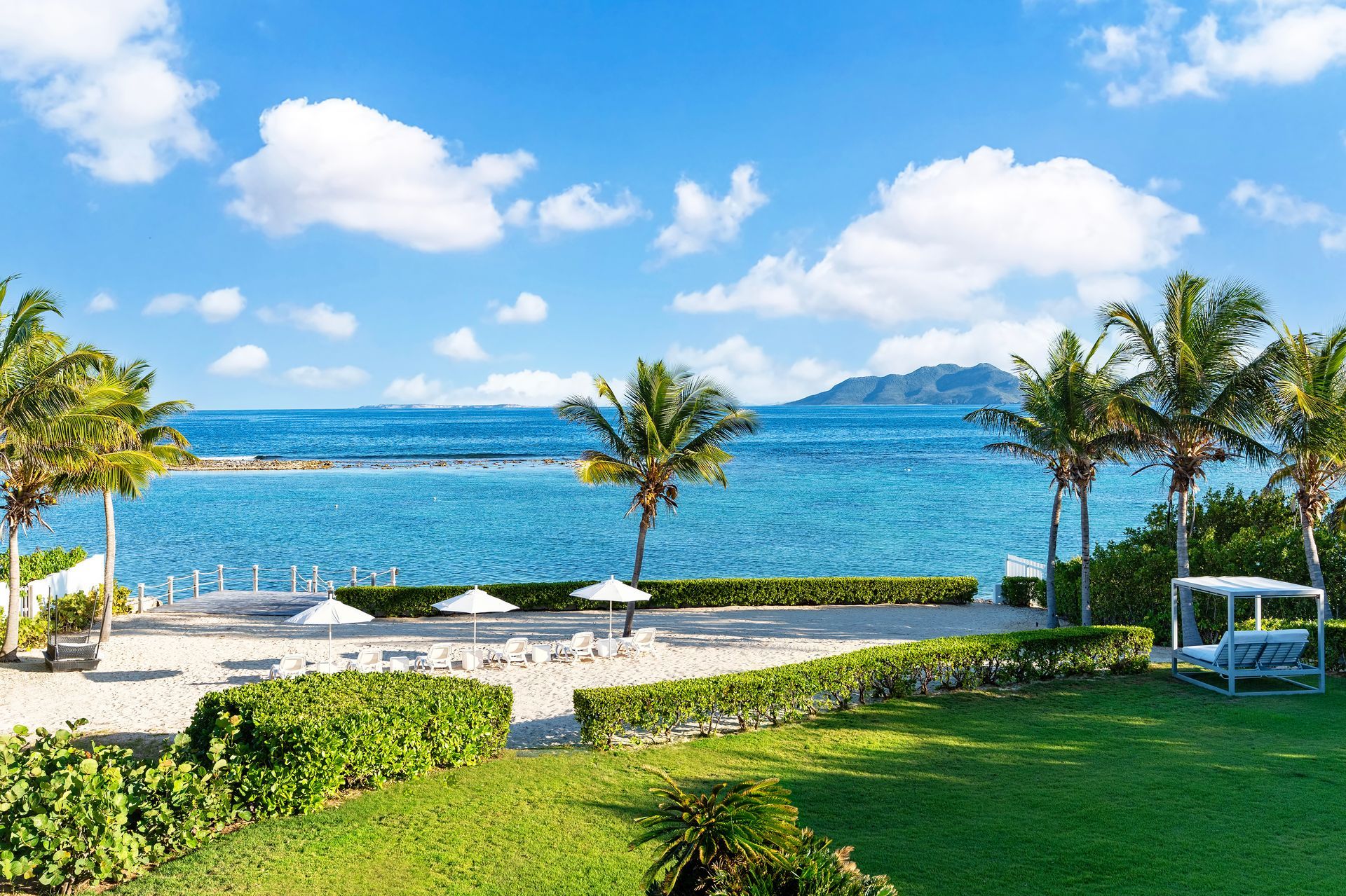 A view of the ocean from a lush green lawn