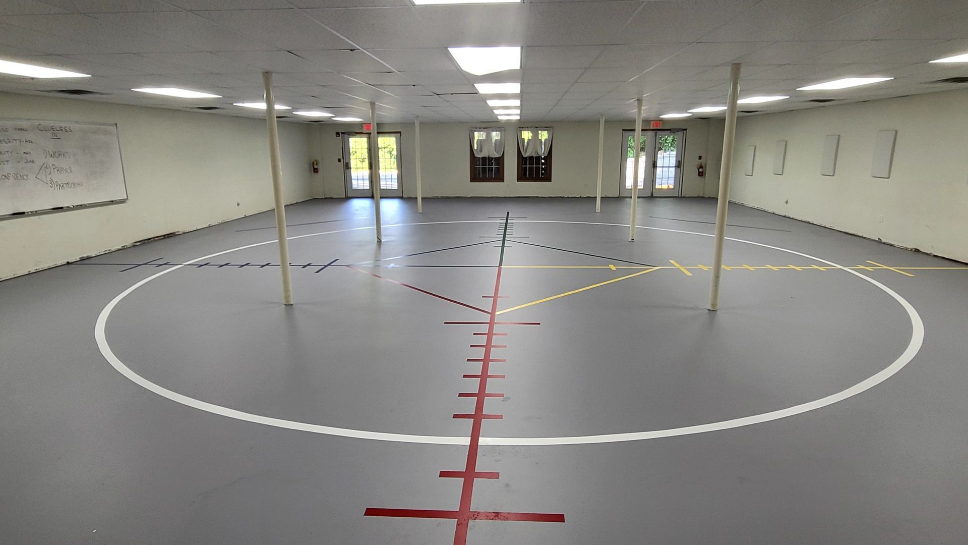 A large empty room with a circle in the middle