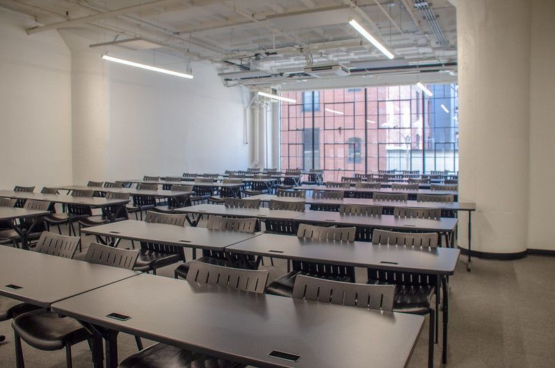 There are many tables and chairs in this room.