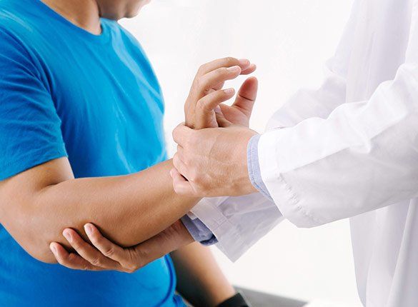Doctor Checking Patient's Wrist — State College, PA — Back To Life Physical Therapy Doctor Checking Patient's Wrist — State College, PA — Back To Life Physical Therapy