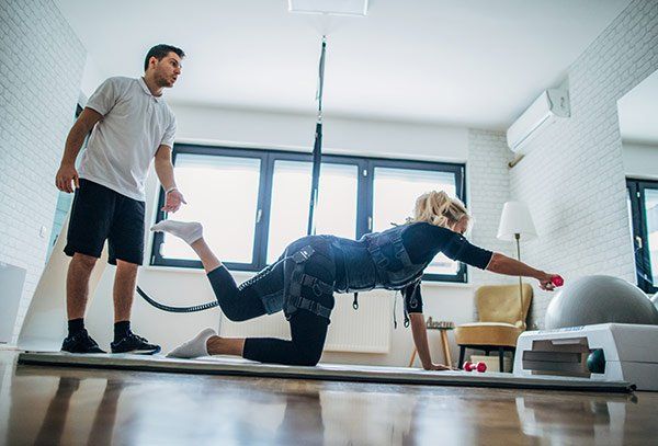 Woman Stretching — State College, PA — Back To Life Physical Therapy Woman Stretching — State College, PA — Back To Life Physical Therapy