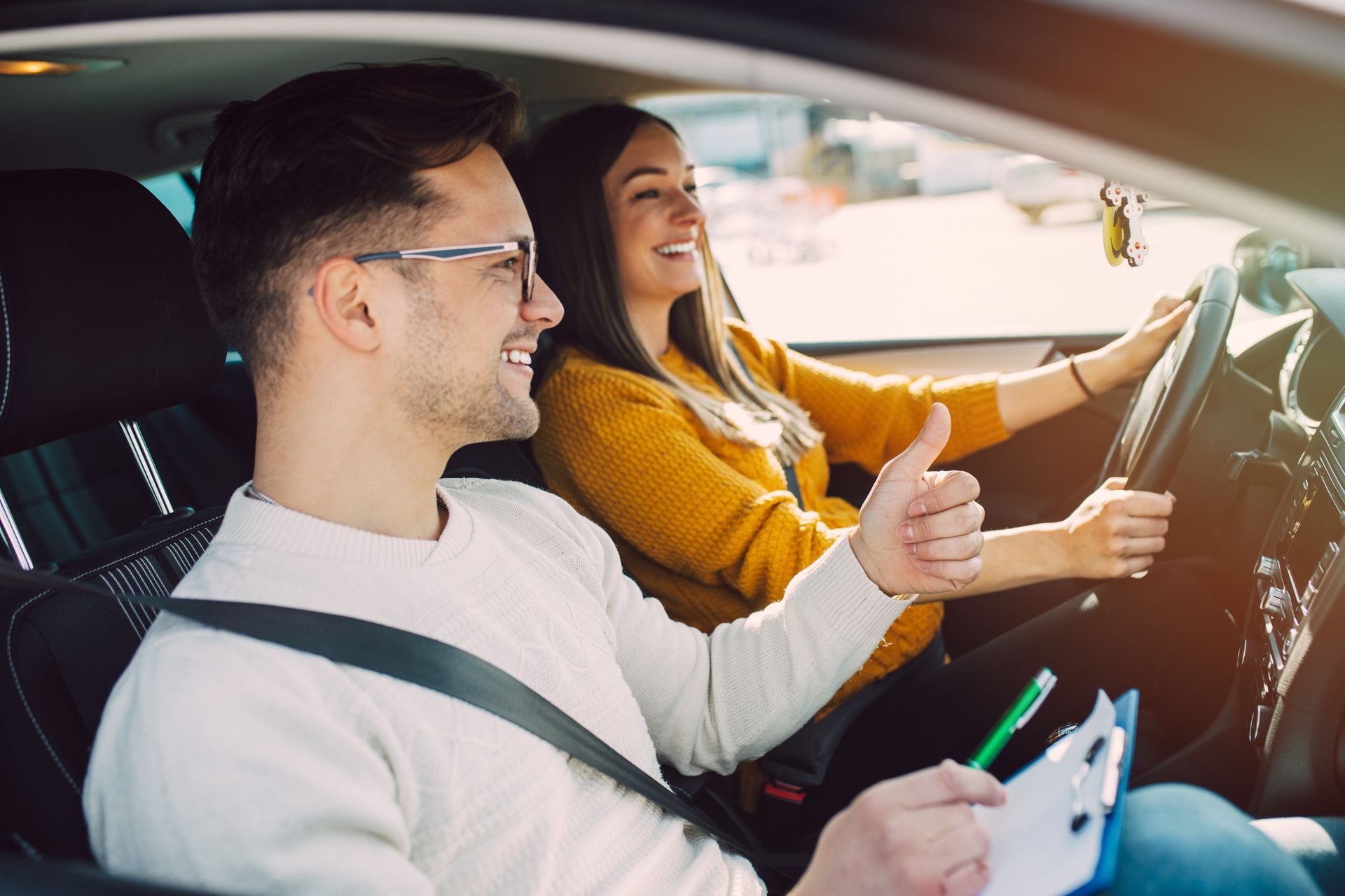Driving school instructor teaching a student safe driving skills
