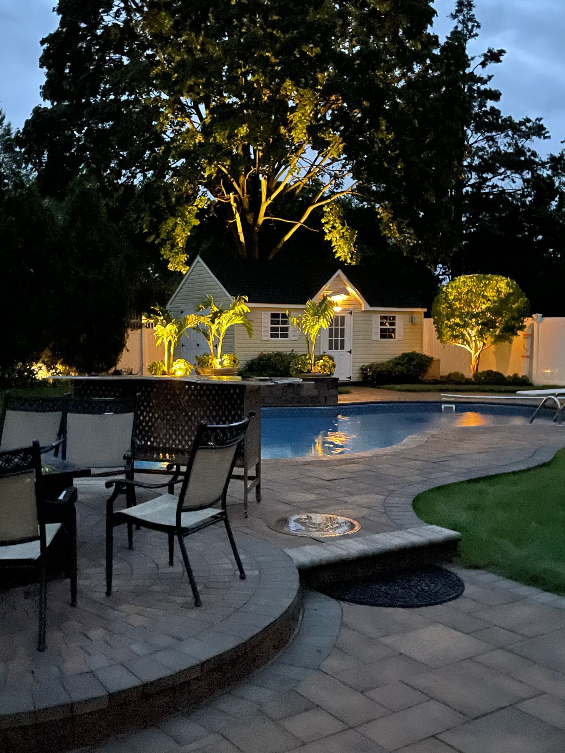 A house with a swimming pool in front of it