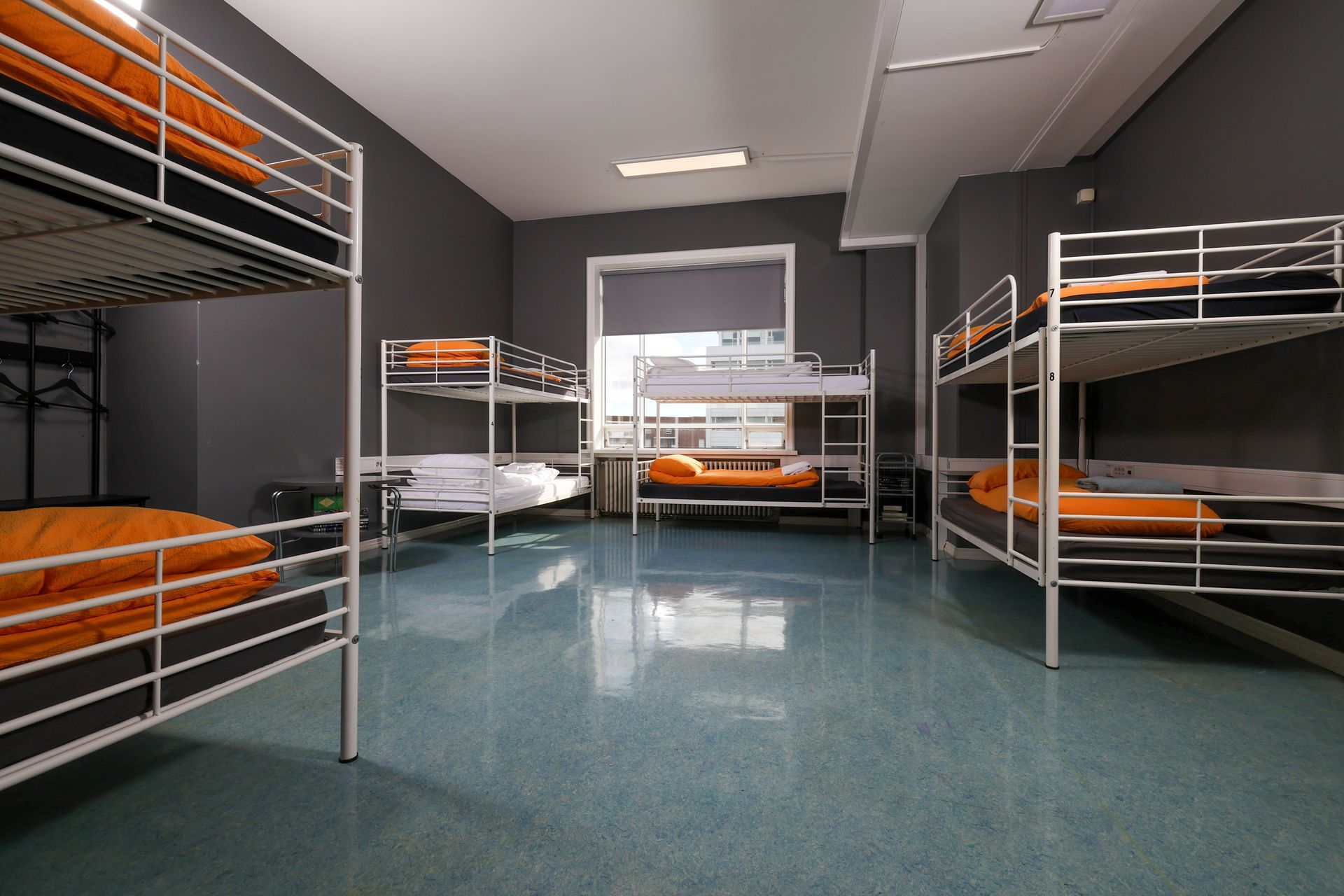 A room filled with bunk beds and a window.