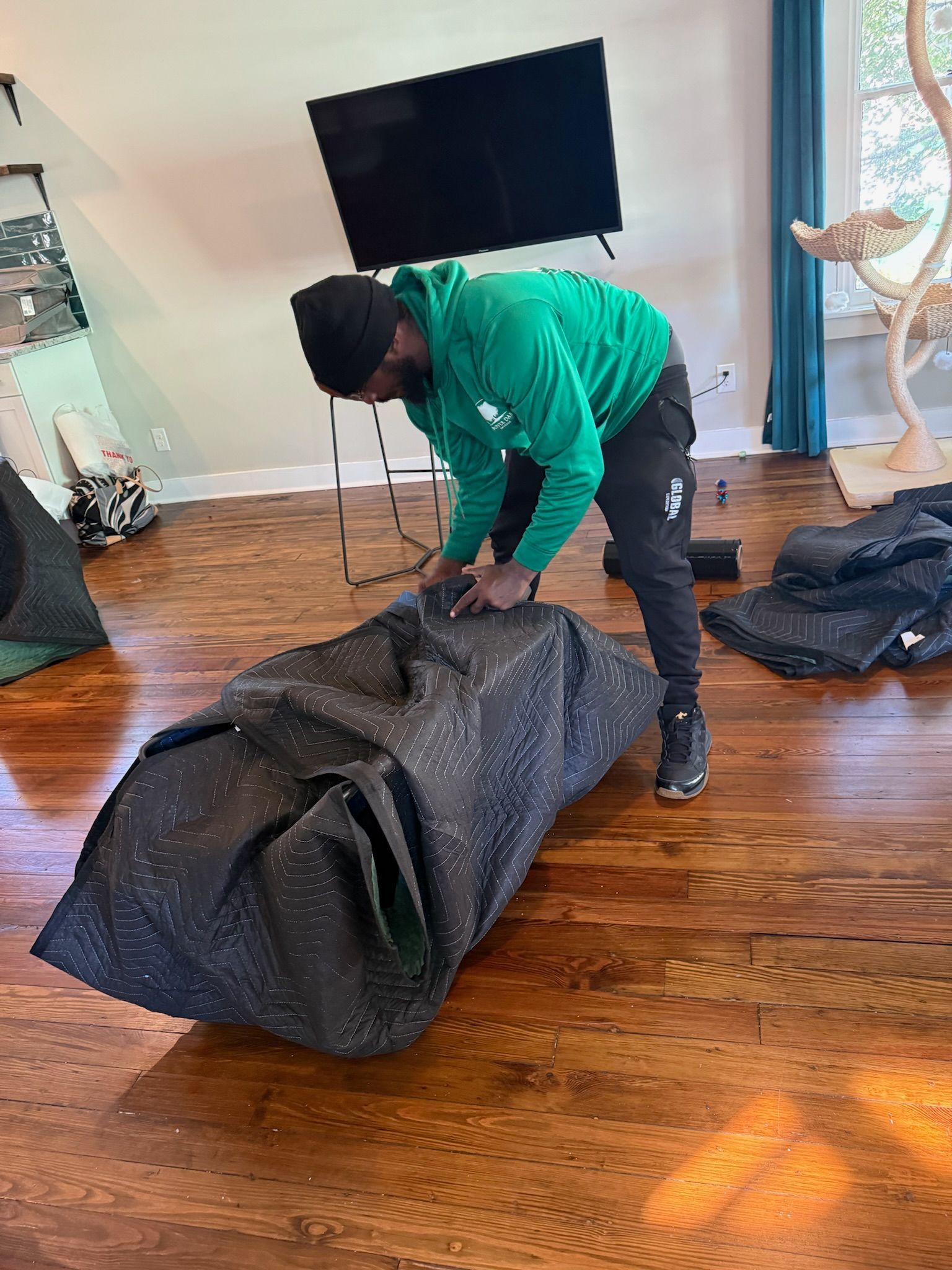 person hammering together an upholstered chair