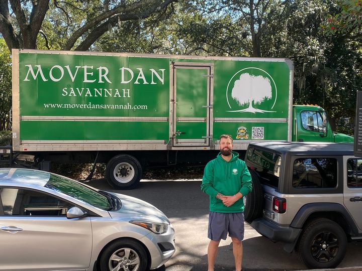 mover carrying boxes out of van