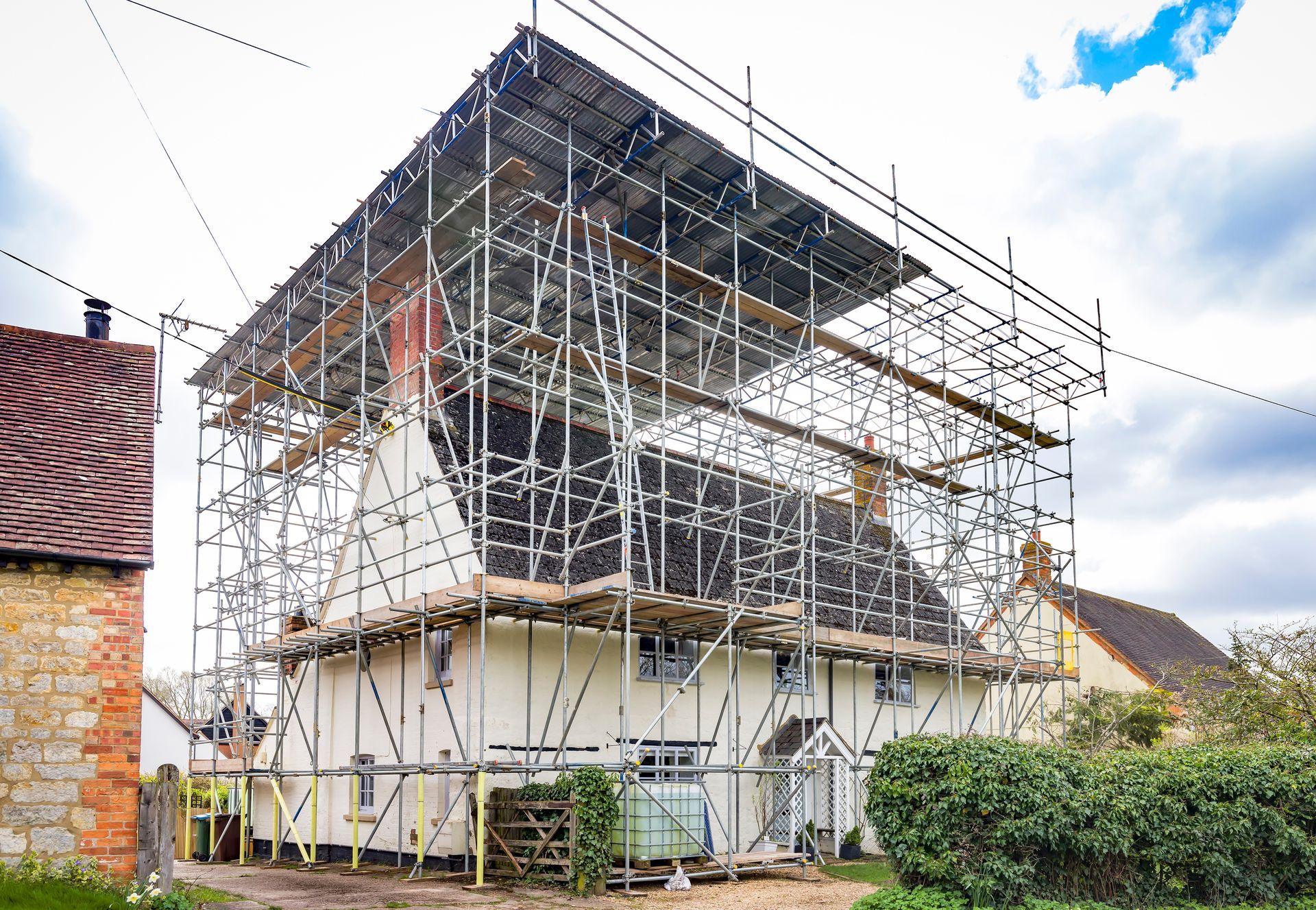 Roof scaffolding and temporary roof canopy over a house. Roof scaffolding and temporary roof canopy over a house.