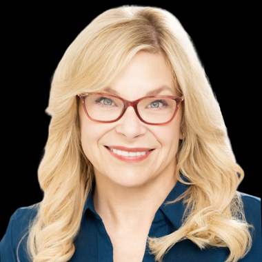 White woman with glasses and blonde hair smiling against grey background