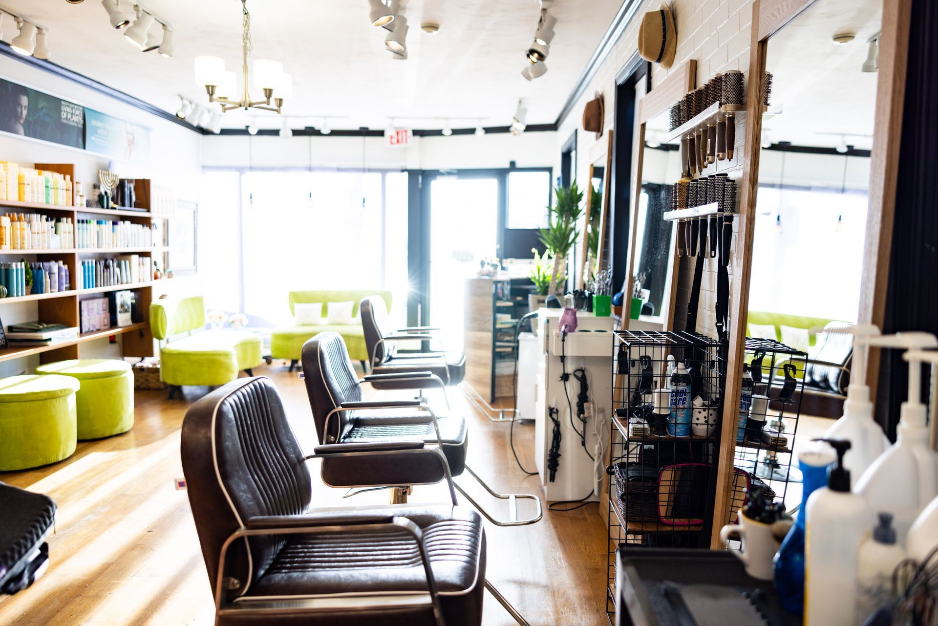A row of chairs are lined up in a hair salon.