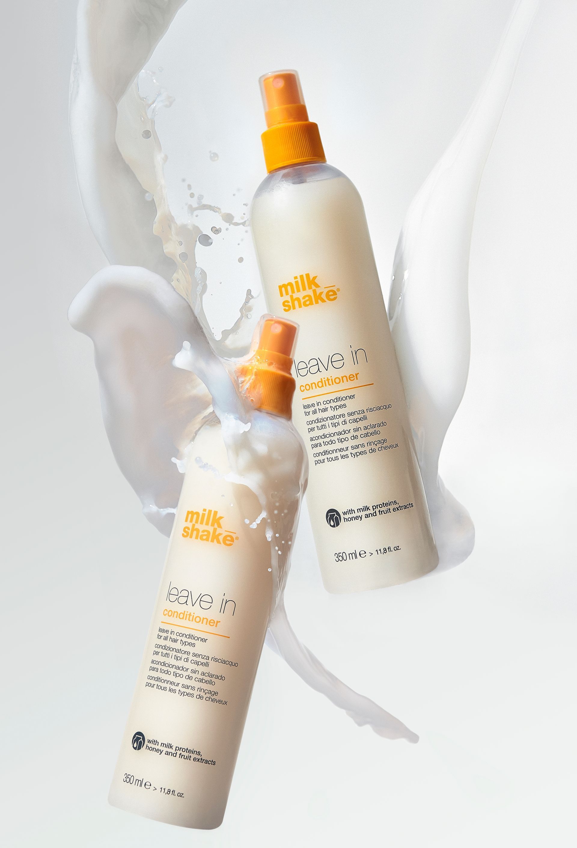Two bottles of milk works spray are sitting next to each other on a table.