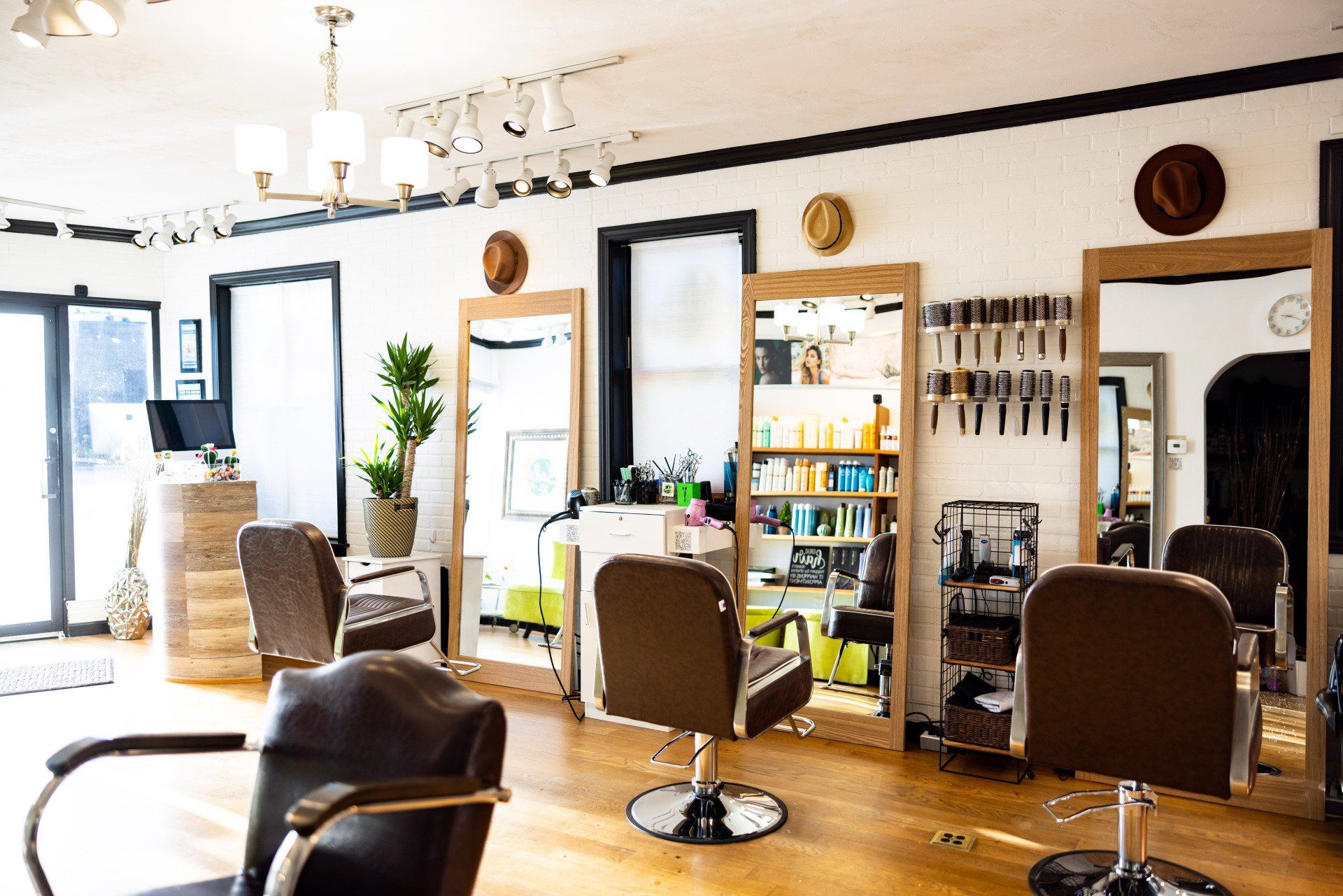 A hair salon with a lot of chairs and mirrors.