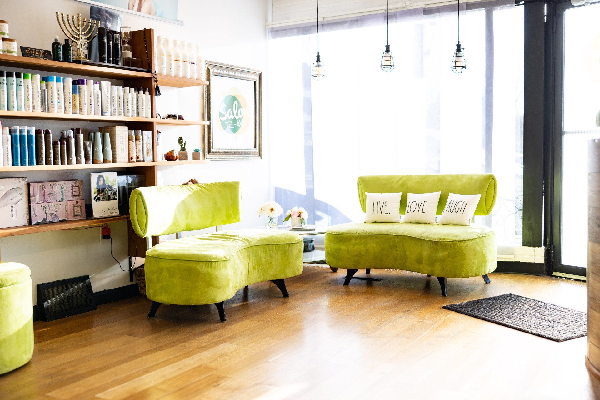 A living room with a green couch and chairs